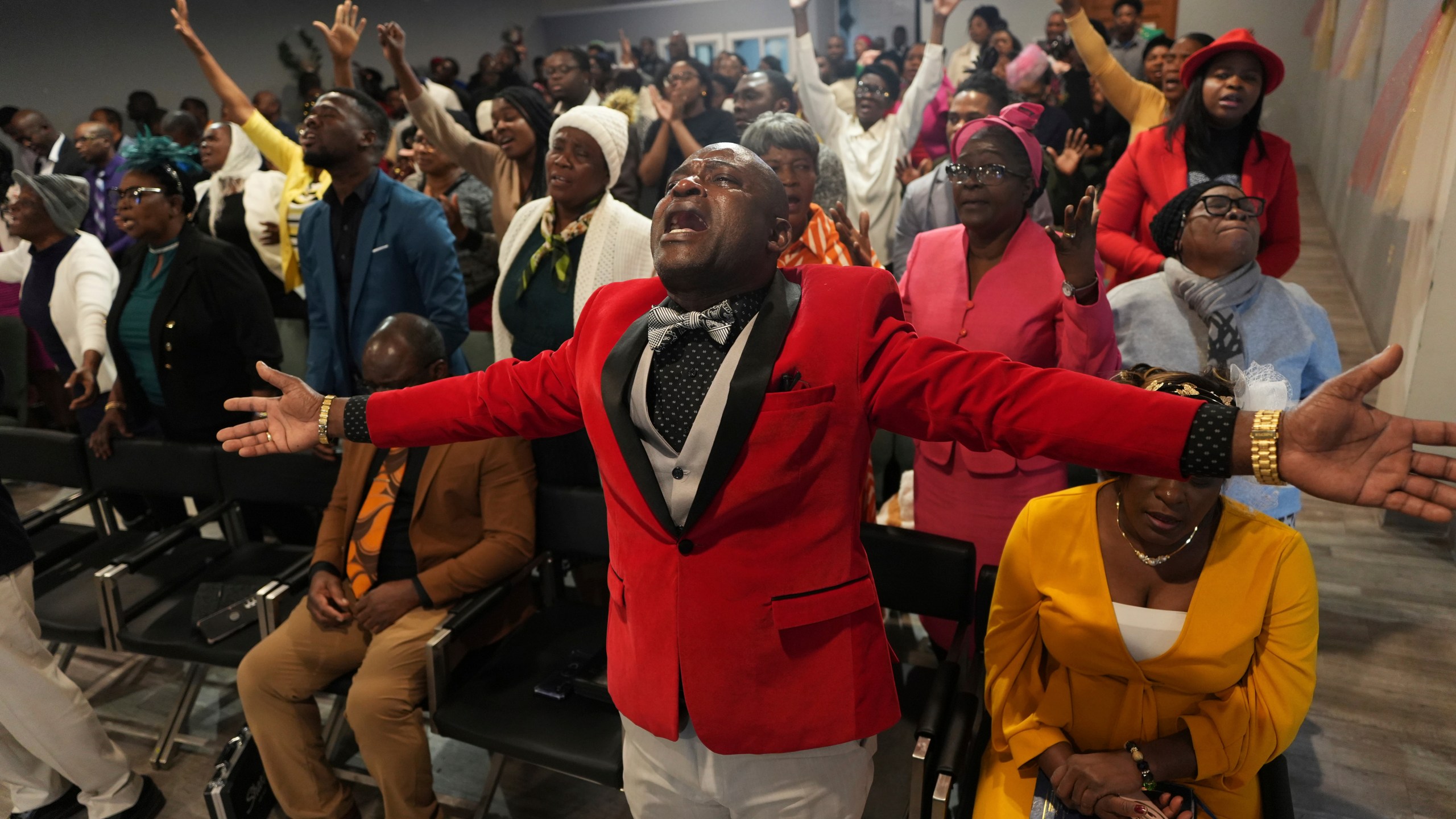 Jean-Michel Gisnel cries out while praying with other congregants at the First Haitian Evangelical Church of Springfield, Sunday, January 26, 2025, in Springfield, Ohio. (AP Photo/Luis Andres Henao)