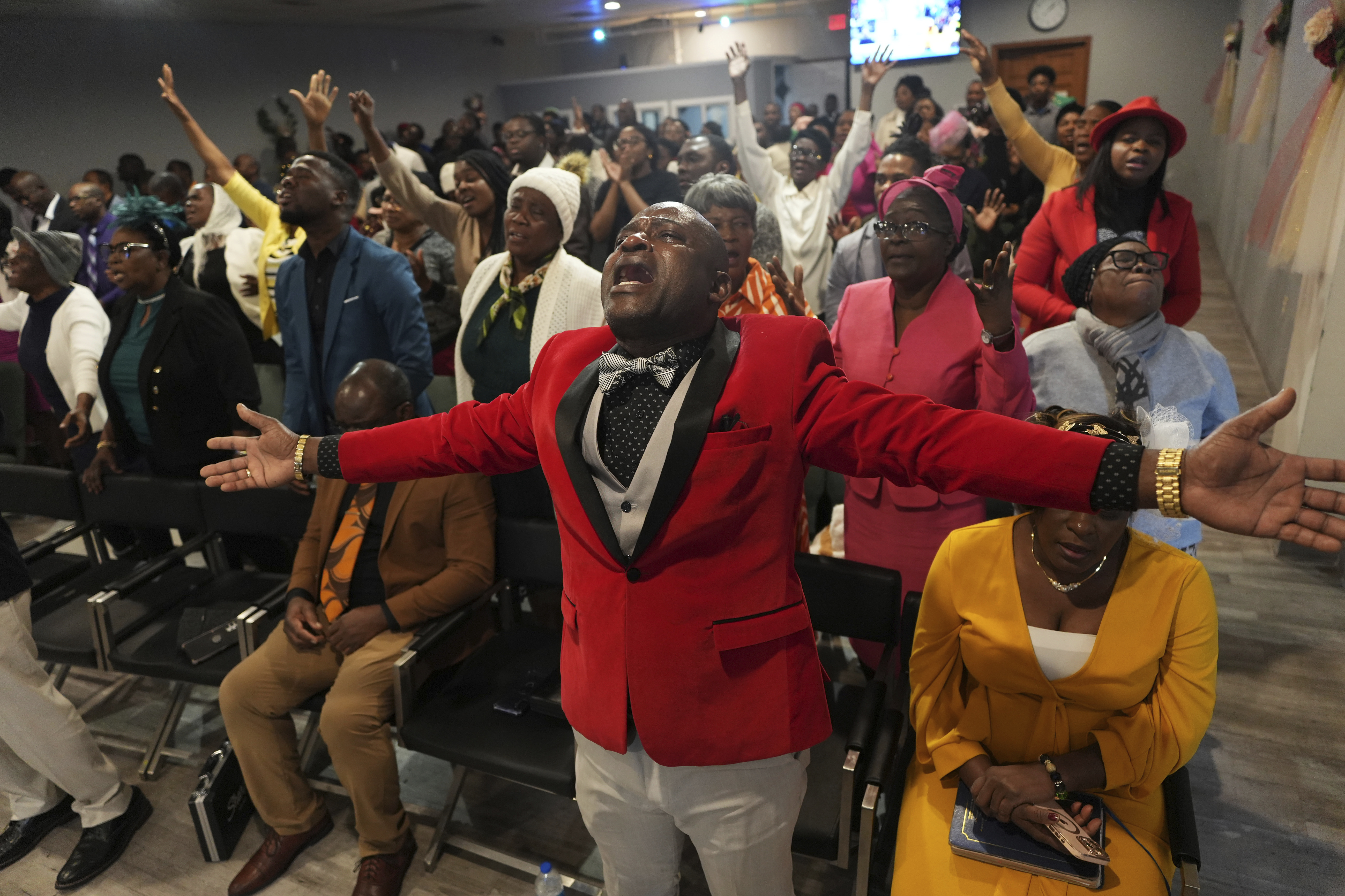 Jean-Michel Gisnel cries out while praying with other congregants at the First Haitian Evangelical Church of Springfield, Sunday, January 26, 2025, in Springfield, Ohio. (AP Photo/Luis Andres Henao)