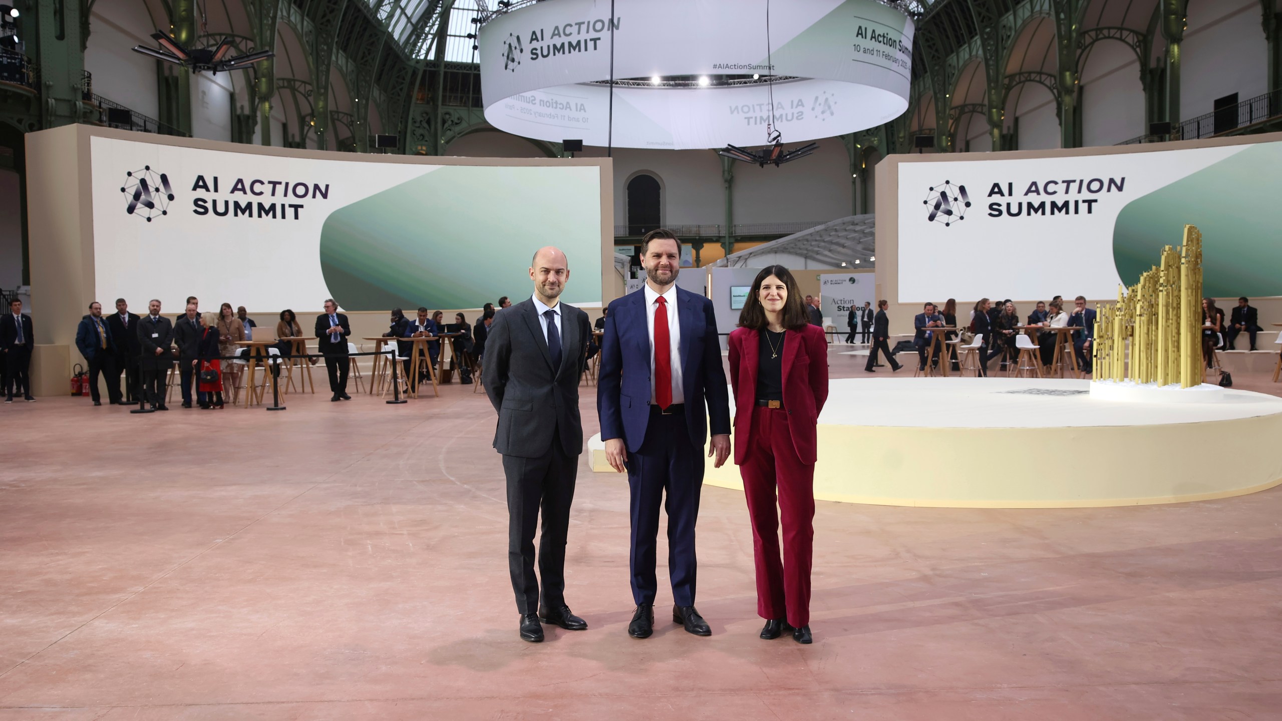 United States Vice-President JD Vance, center, is welcomed by French Foreign Minister Jean-Noel Barrot, left, and French businesswoman Clara Chappaz at the Grand Palais during the Artificial Intelligence Action Summit in Paris, Tuesday, Feb. 11, 2025. (AP Photo/Thomas Padilla)