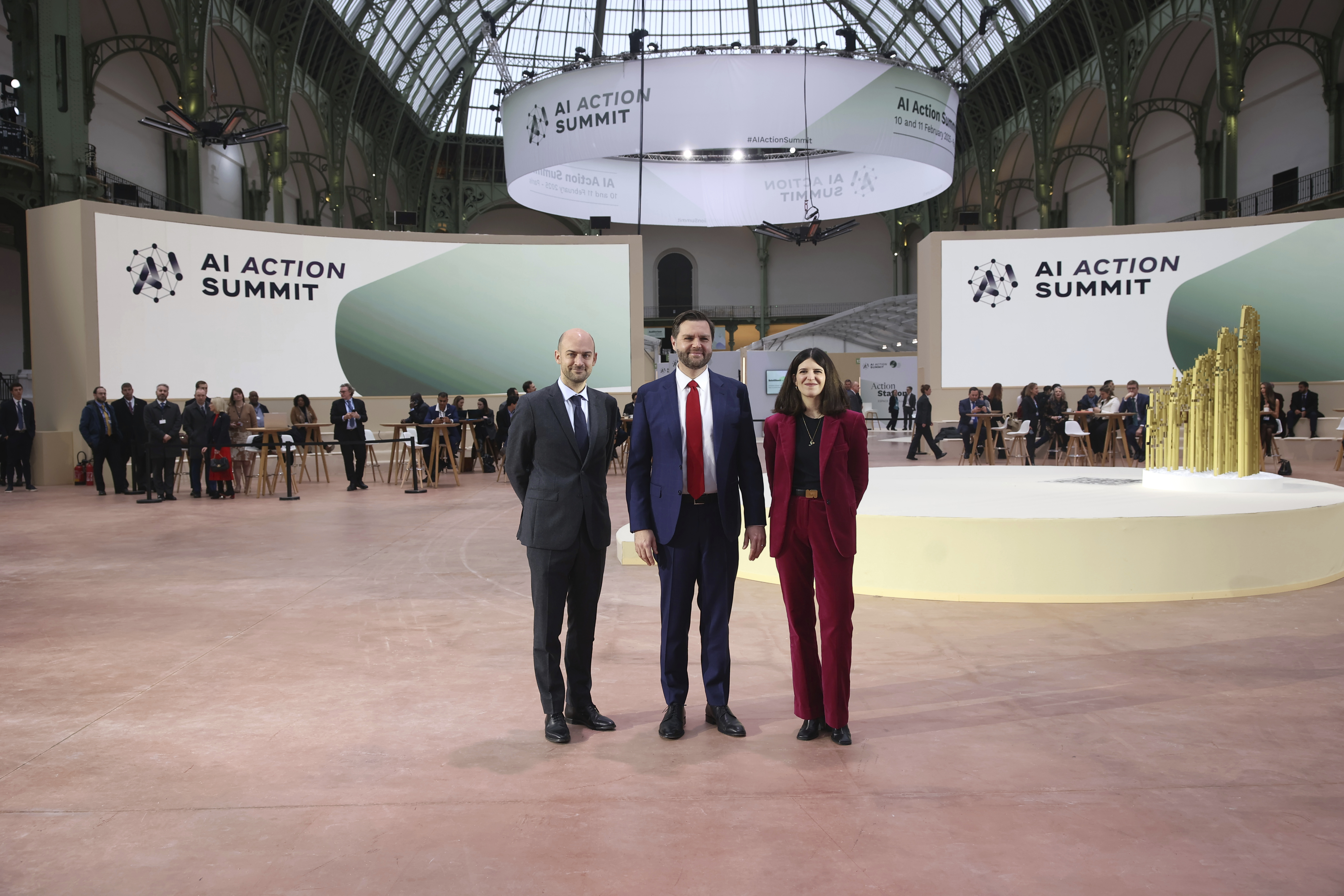 United States Vice-President JD Vance, center, is welcomed by French Foreign Minister Jean-Noel Barrot, left, and French businesswoman Clara Chappaz at the Grand Palais during the Artificial Intelligence Action Summit in Paris, Tuesday, Feb. 11, 2025. (AP Photo/Thomas Padilla)