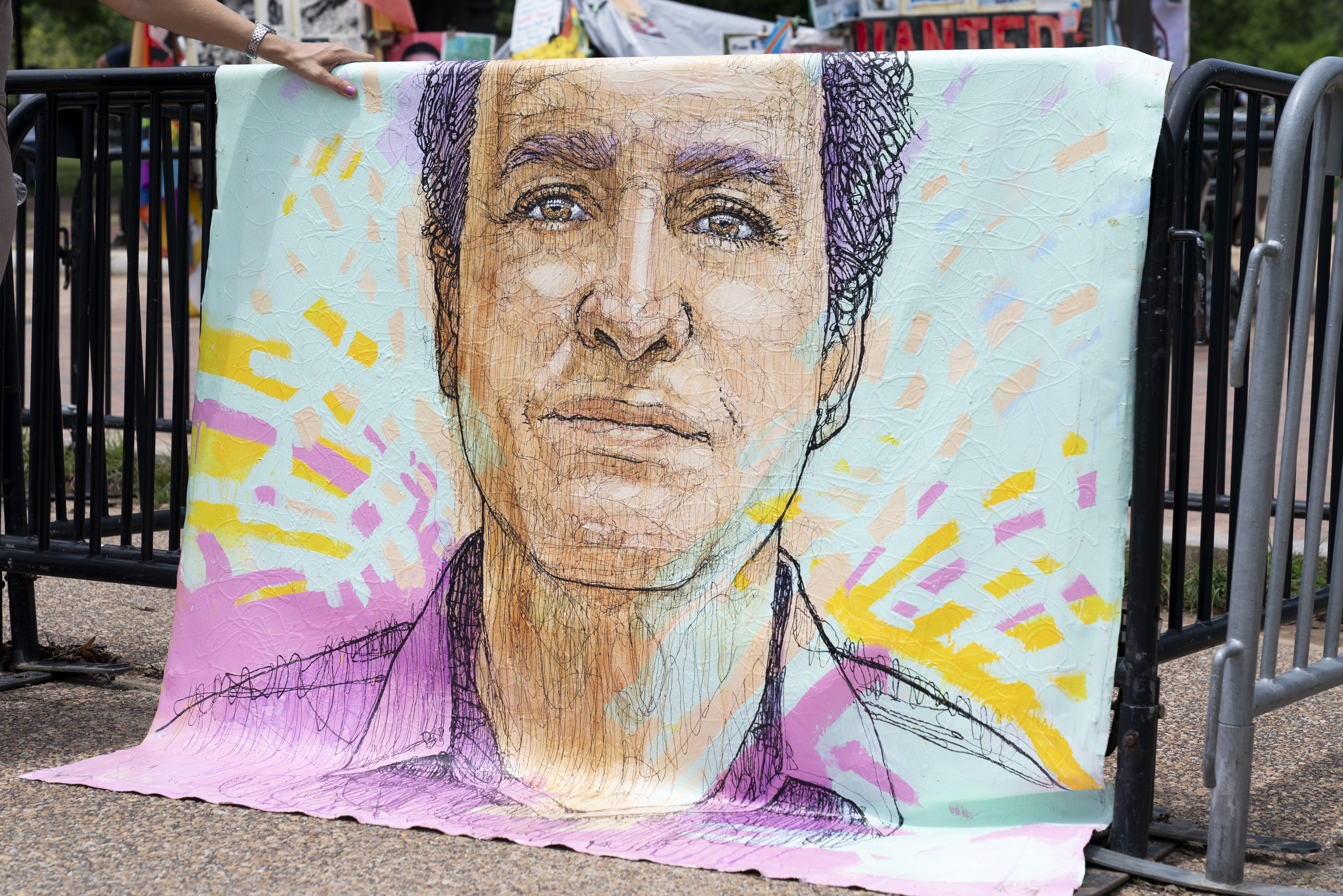 FILE - A drawn portrait of Marc Fogel, who has been detained in Russia since August 2021, hangs on rails outside of the White House during a demonstration organized by his family, July 15, 2023, in Washington. (AP Photo/Stephanie Scarbrough, File)