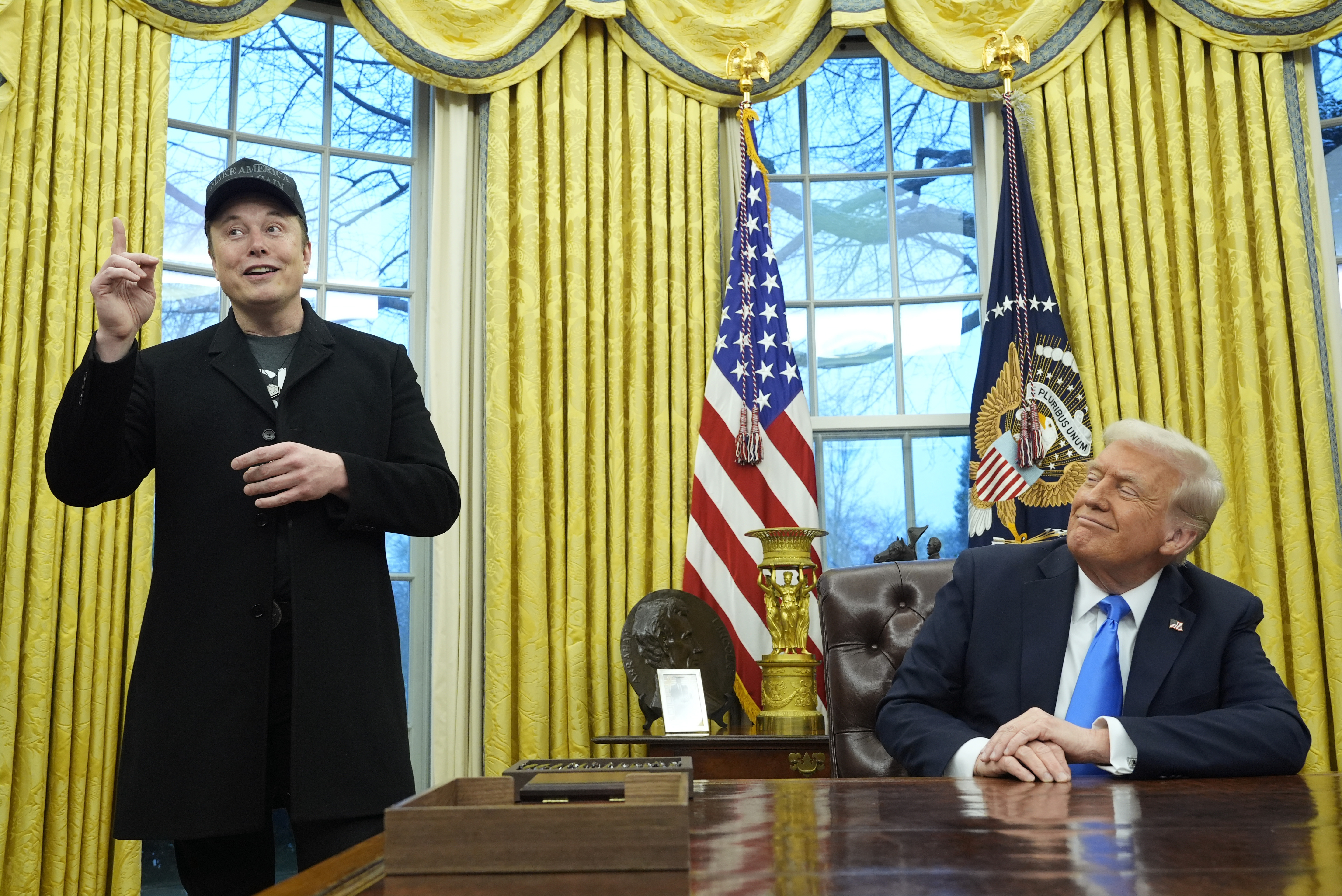 President Donald Trump listens as Elon Musk speaks in the Oval Office at the White House, Tuesday, Feb. 11, 2025, in Washington. (Photo/Alex Brandon)