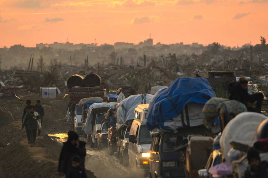 Displaced Palestinians, traveling in vehicles, wait in line to pass through a security checkpoint at the Netzarim corridor as they make their way from central Gaza to their homes in the northern Gaza Strip, Monday, Feb. 10, 2025. (AP Photo/Abdel Kareem Hana)