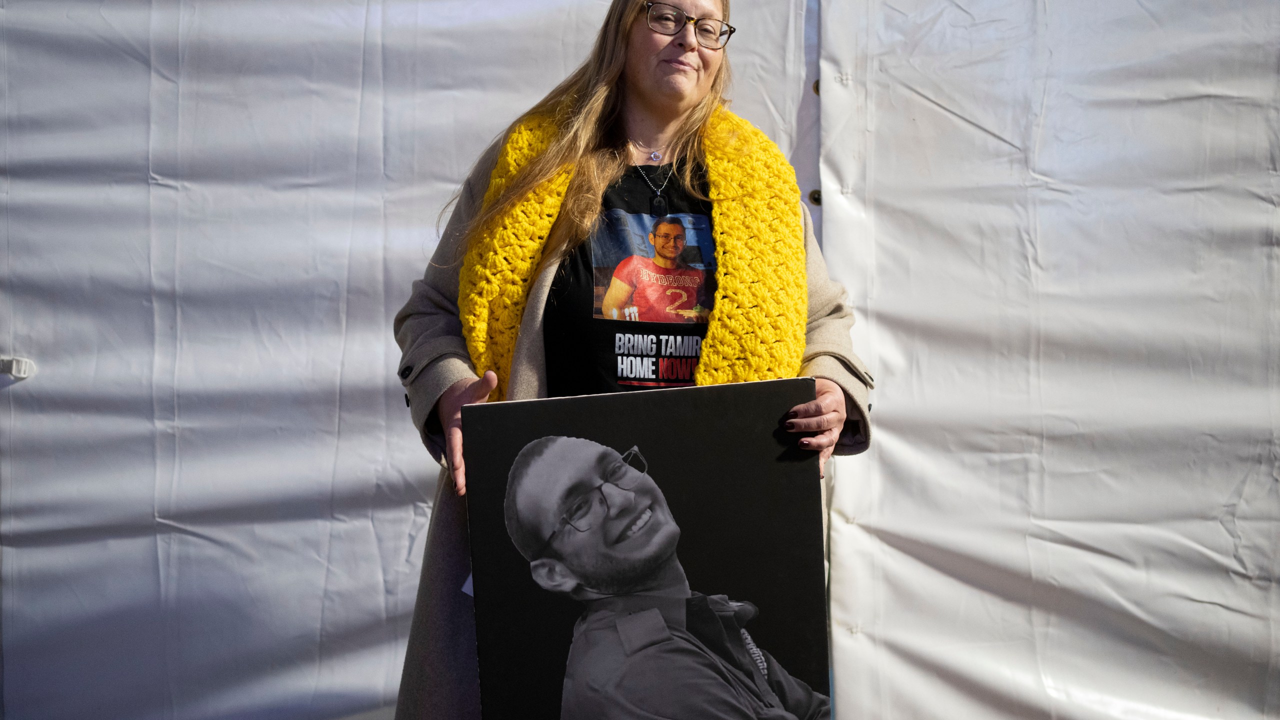 FILE - Herut Nimrodi poses for a portrait with a poster of her son, Tamir Nimrodi, an Israeli soldier taken hostage on Oct. 7, 2023, and being held by Hamas militants in the Gaza Strip, at a rally for hostages and their families in Tel Aviv, Israel, Jan. 14, 2025. (AP Photo/Maya Alleruzzo, File)