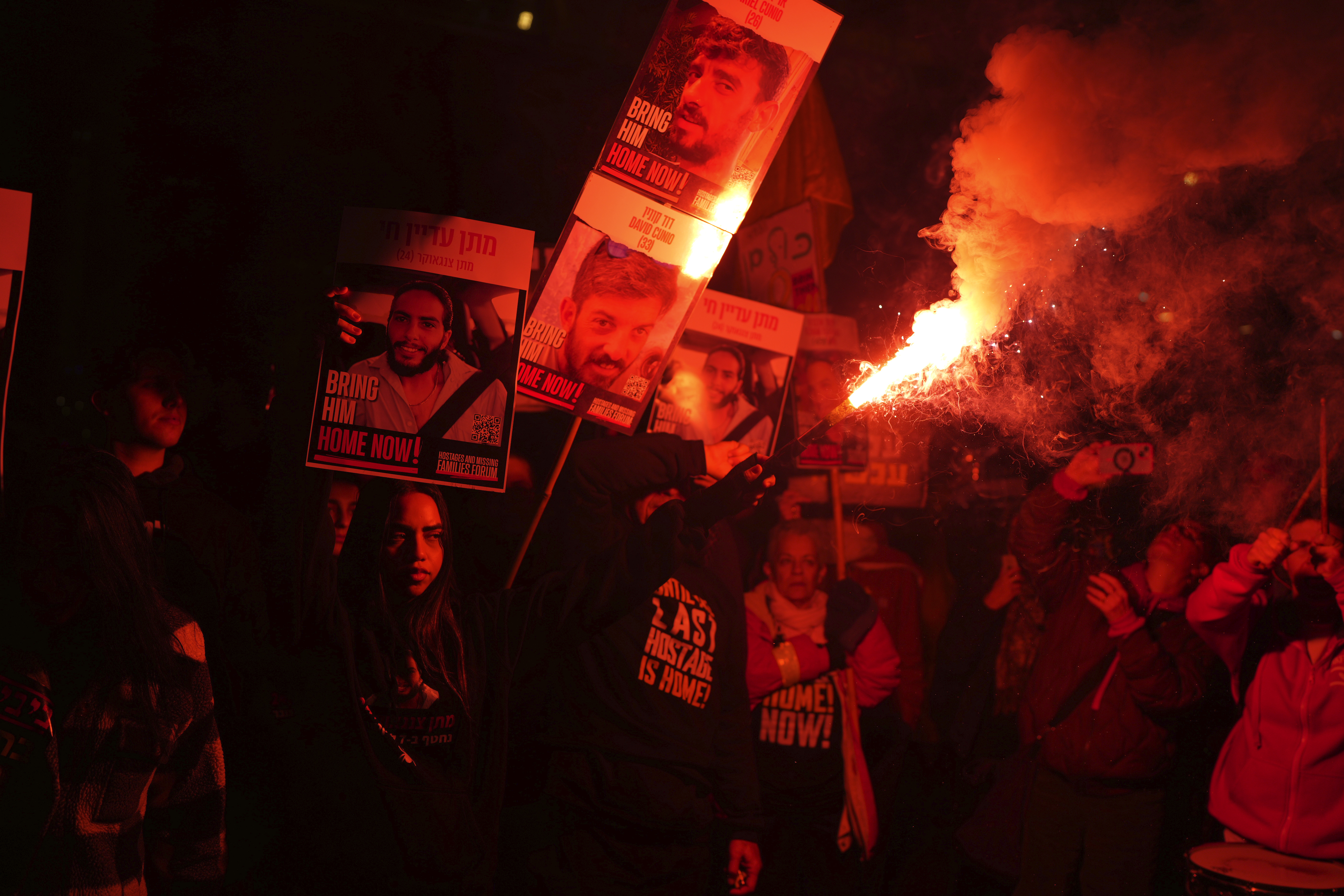 Relatives of hostages, held by Hamas in the Gaza Strip, protest outside of Israel's Ministry of Defense in Tel Aviv, Monday, Feb. 10, 2025, after the militant group announced it would delay hostage releases in the Gaza Strip after accusing Israel of violating a fragile ceasefire. (AP Photo/Ohad Zwigenberg)