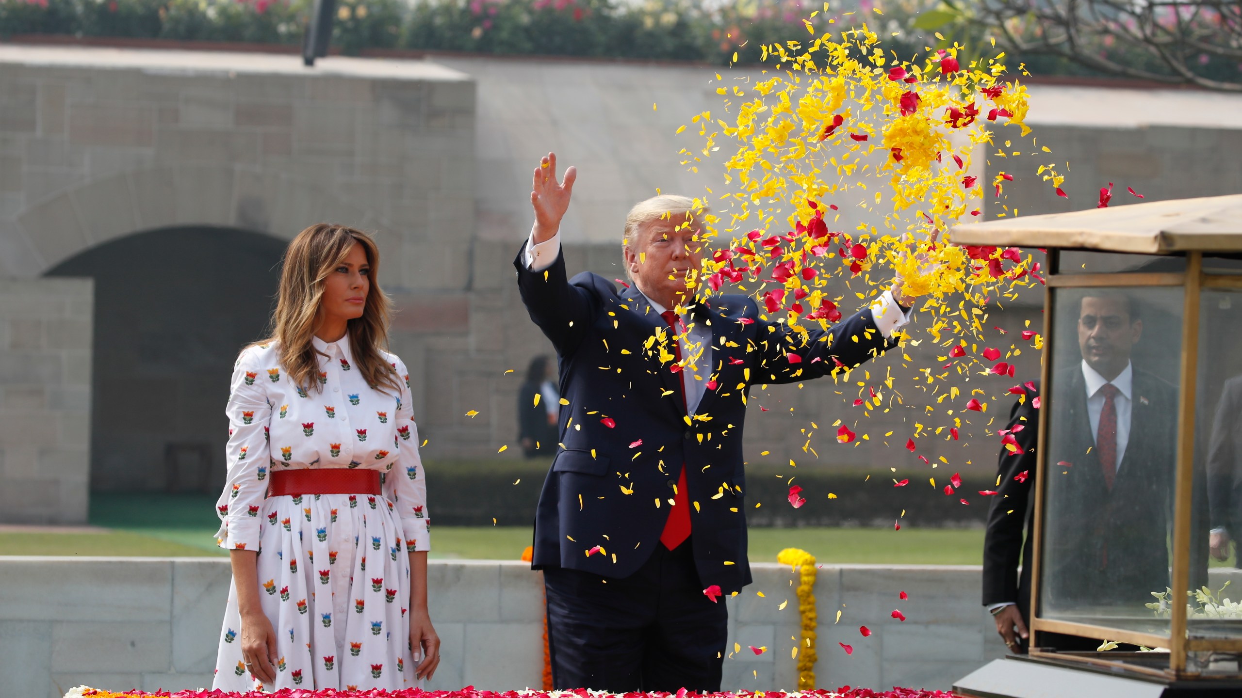 U.S. President Donald Trump offers floral respects, with first lady Melania Trump standing beside him, at Raj Ghat, the memorial for Mahatma Gandhi, in New Delhi, India, Feb. 25, 2020. (AP Photo/Alex Brandon, File)