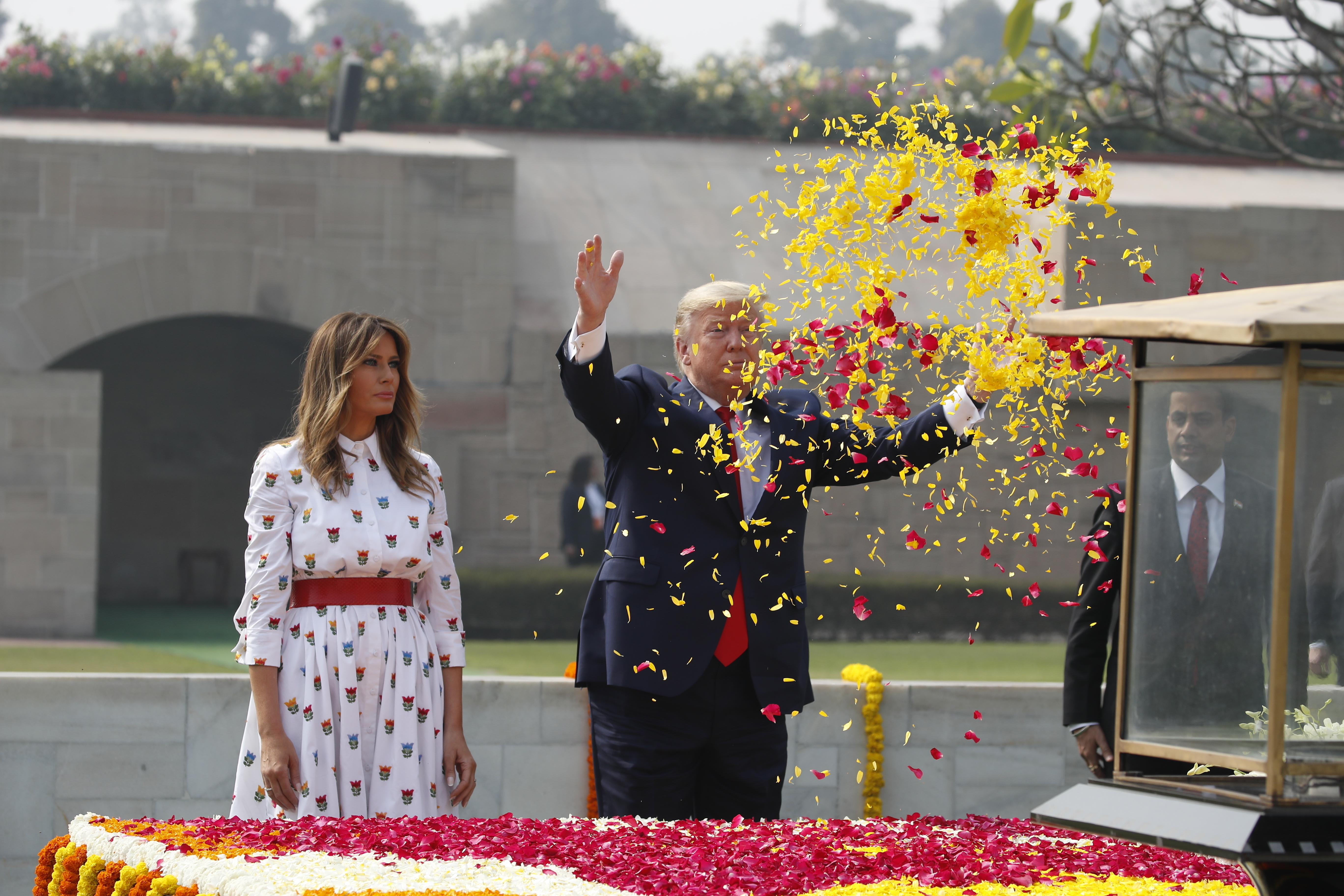 U.S. President Donald Trump offers floral respects, with first lady Melania Trump standing beside him, at Raj Ghat, the memorial for Mahatma Gandhi, in New Delhi, India, Feb. 25, 2020. (AP Photo/Alex Brandon, File)