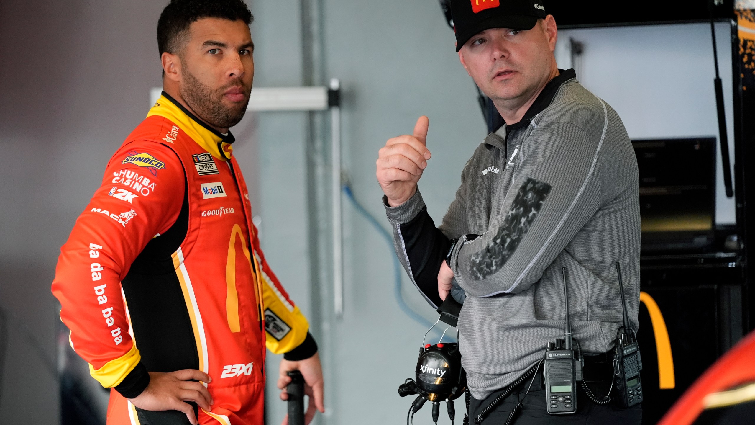 Bubba Wallace, left, talks with his crew chief Charles Denise in the garage during practice for the NASCAR Daytona 500 auto race at Daytona International Speedway, Wednesday, Feb. 12, 2025, in Daytona Beach, Fla. (AP Photo/John Raoux)