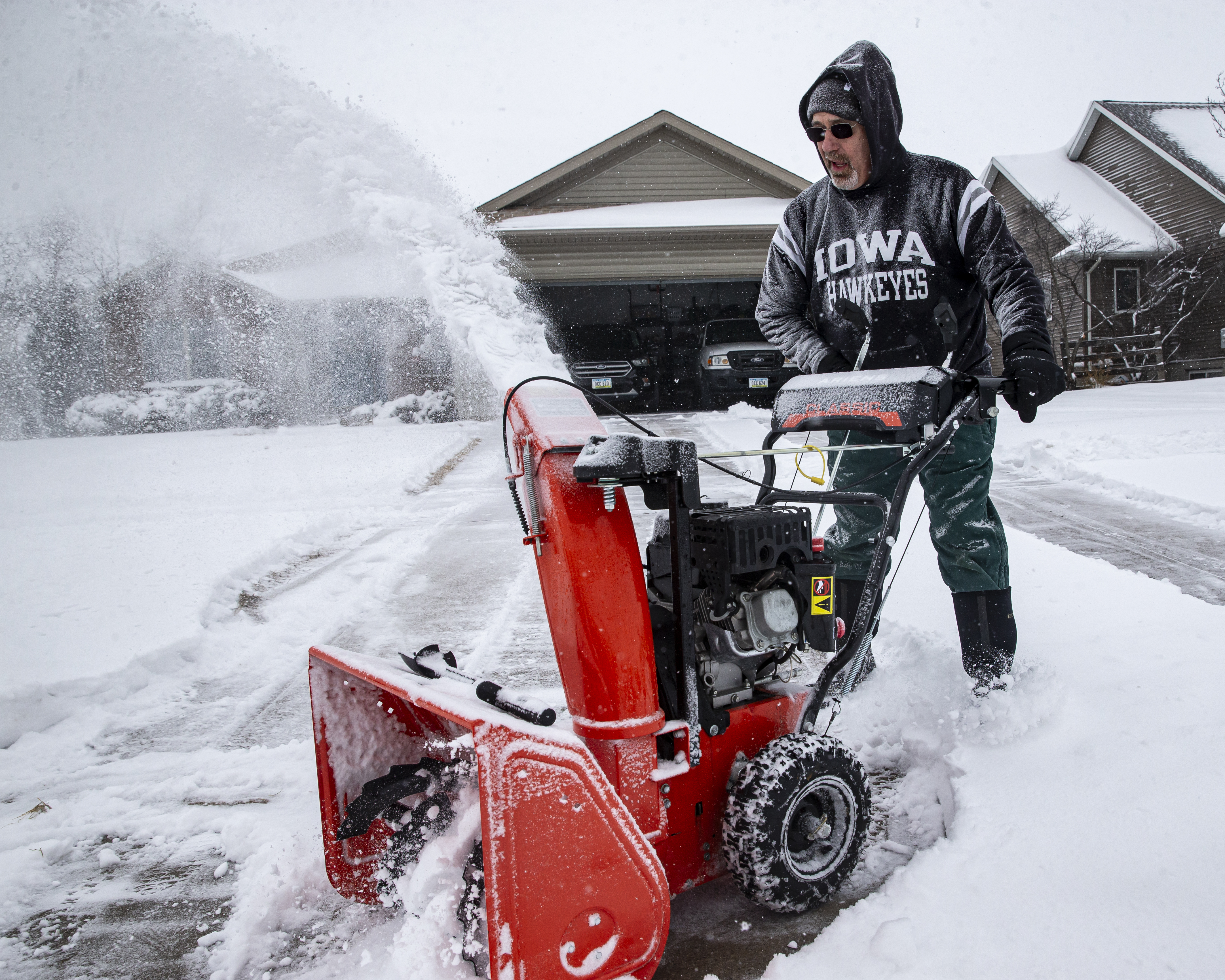 Rick Boland uses a snowblower to clear snow from his driveway in North Liberty, Iowa, Wednesday, Feb. 12, 2025. (Nick Rohlman/The Gazette via AP)