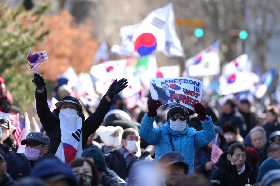 Supporters of impeached South Korean President Yoon Suk Yeol hold signs during a rally to oppose his impeachment near the Constitutional Court in Seoul, South Korea, Thursday, Feb. 13, 2025. (AP Photo/Lee Jin-man)