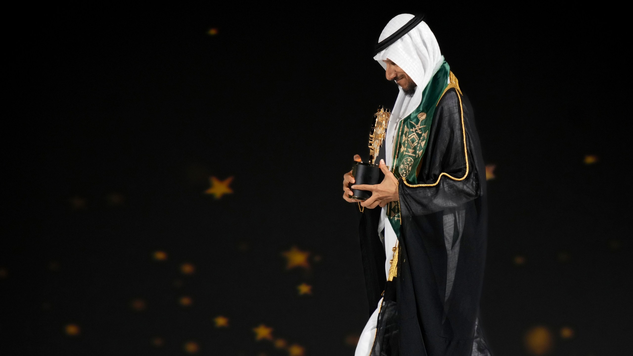 Saudi Arabian teacher Mansour bin Abdullah Al-Mansour, walks off the stage after receiving the Global Teacher Prize trophy from Dubai Crown Prince Sheikh Hamdan bin Mohammed Al Maktoum at a ceremony in Dubai, United Arab Emirates, Thursday, Feb. 13, 2025. (AP Photo/Altaf Qadri)