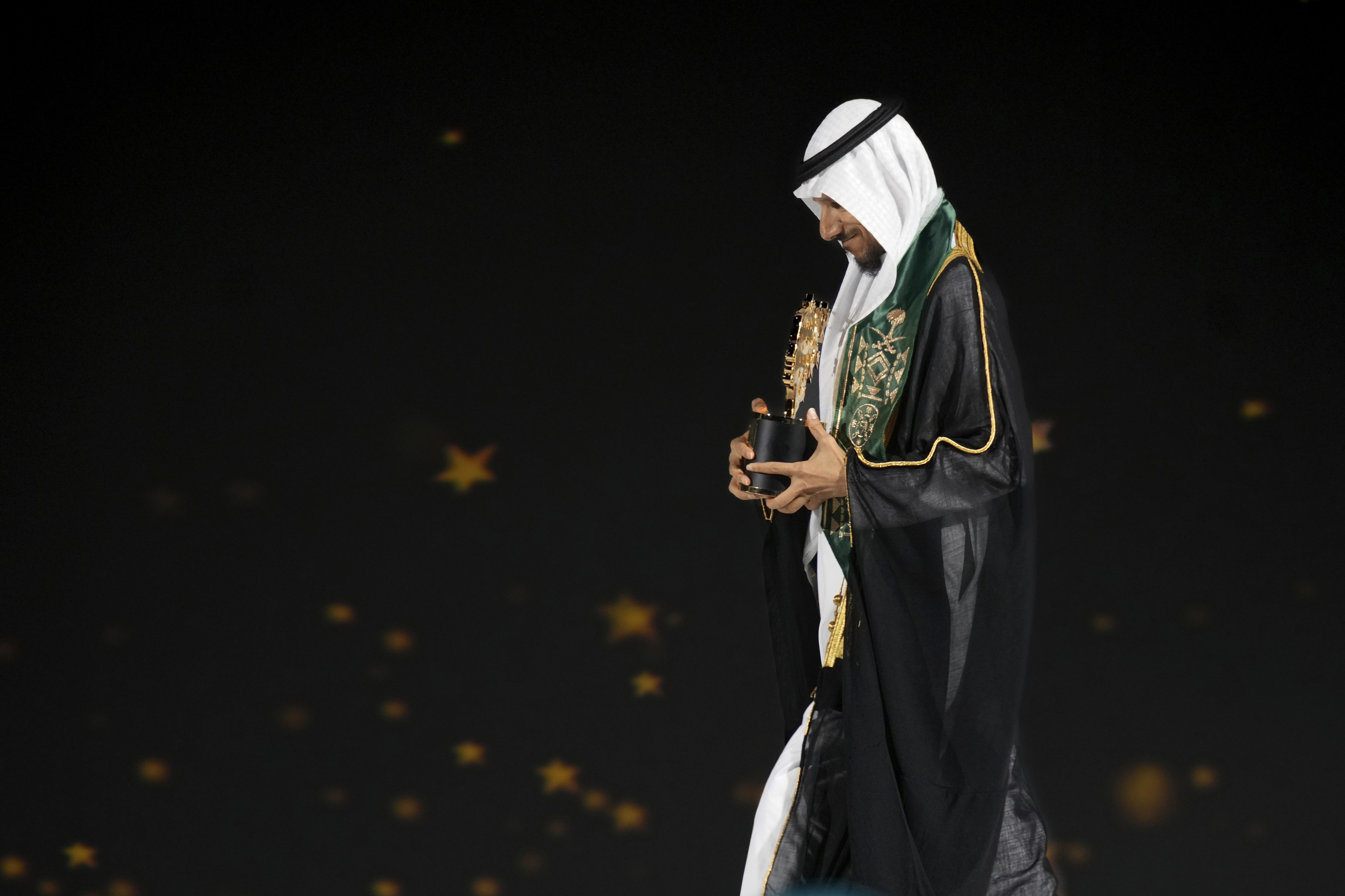 Saudi Arabian teacher Mansour bin Abdullah Al-Mansour, walks off the stage after receiving the Global Teacher Prize trophy from Dubai Crown Prince Sheikh Hamdan bin Mohammed Al Maktoum at a ceremony in Dubai, United Arab Emirates, Thursday, Feb. 13, 2025. (AP Photo/Altaf Qadri)