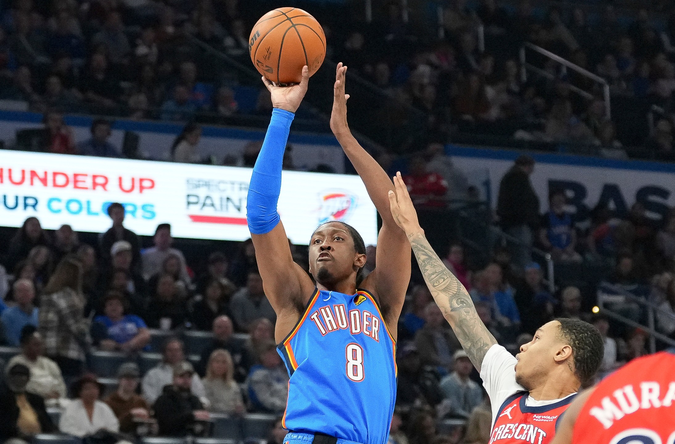 Oklahoma City Thunder forward Jalen Williams, left, looks to shoot over New Orleans Pelicans guard Jordan Hawkins, right, during the first half of an NBA basketball game, Monday, Feb. 10, 2025, in Oklahoma City. (AP Photo/Kyle Phillips)