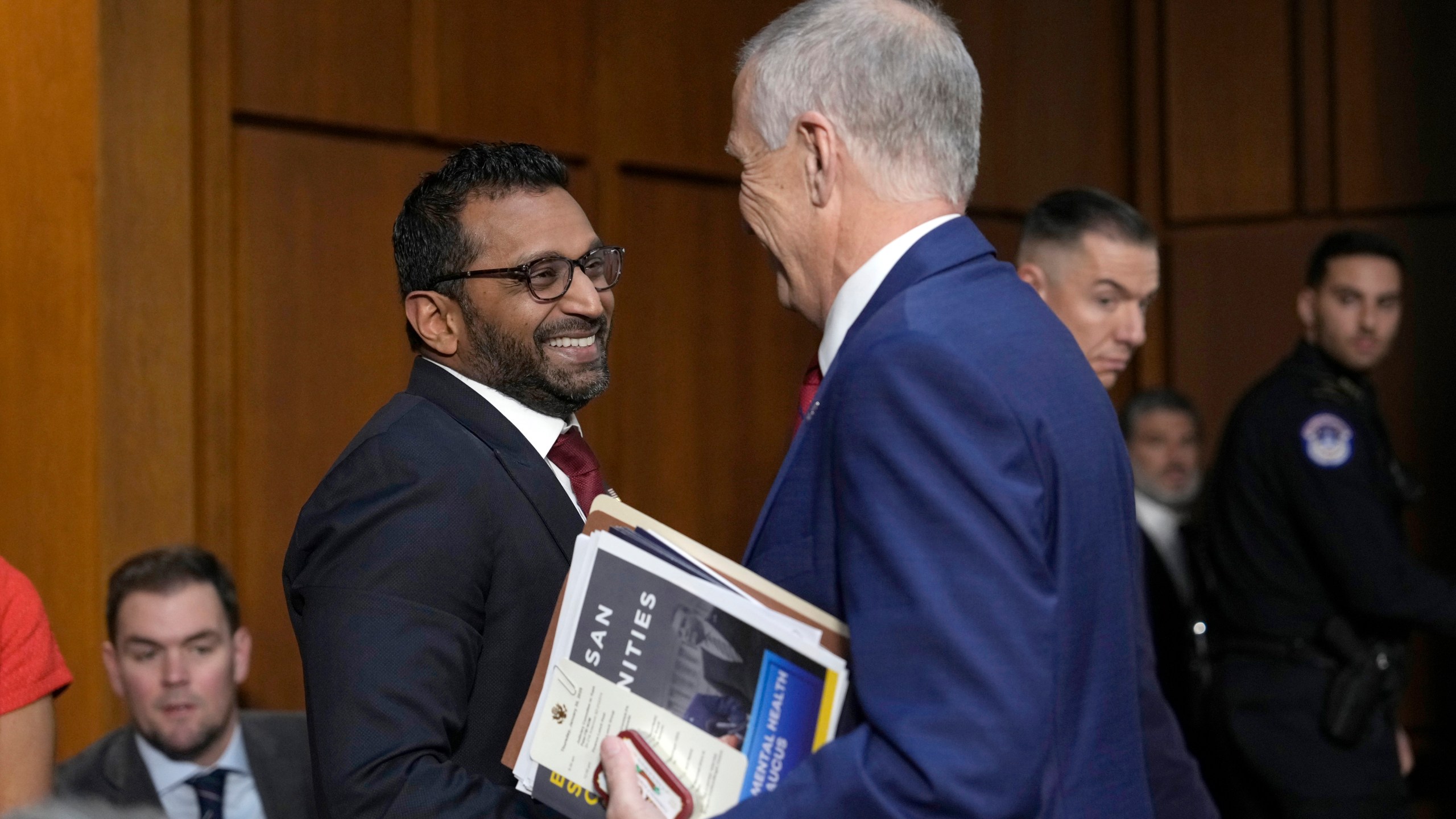 Kash Patel, President Donald Trump's choice to be director of the FBI, left, shakes the hand of Sen. Thom Tillis, R-N.C., as he departs following a confirmation hearing before the Senate Judiciary Committee at the Capitol in Washington, Thursday, Jan. 30, 2025. (AP Photo/Ben Curtis)