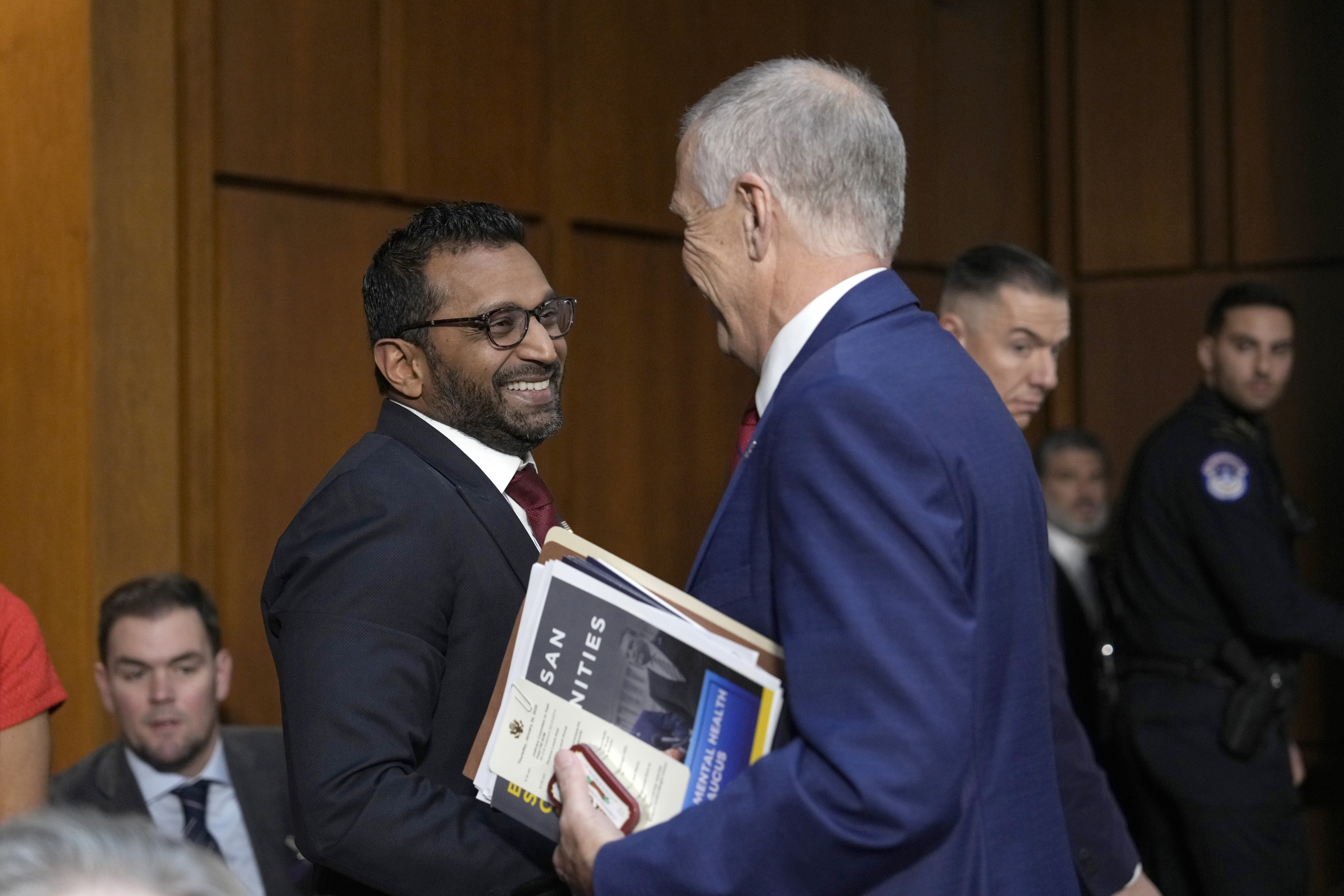 Kash Patel, President Donald Trump's choice to be director of the FBI, left, shakes the hand of Sen. Thom Tillis, R-N.C., as he departs following a confirmation hearing before the Senate Judiciary Committee at the Capitol in Washington, Thursday, Jan. 30, 2025. (AP Photo/Ben Curtis)