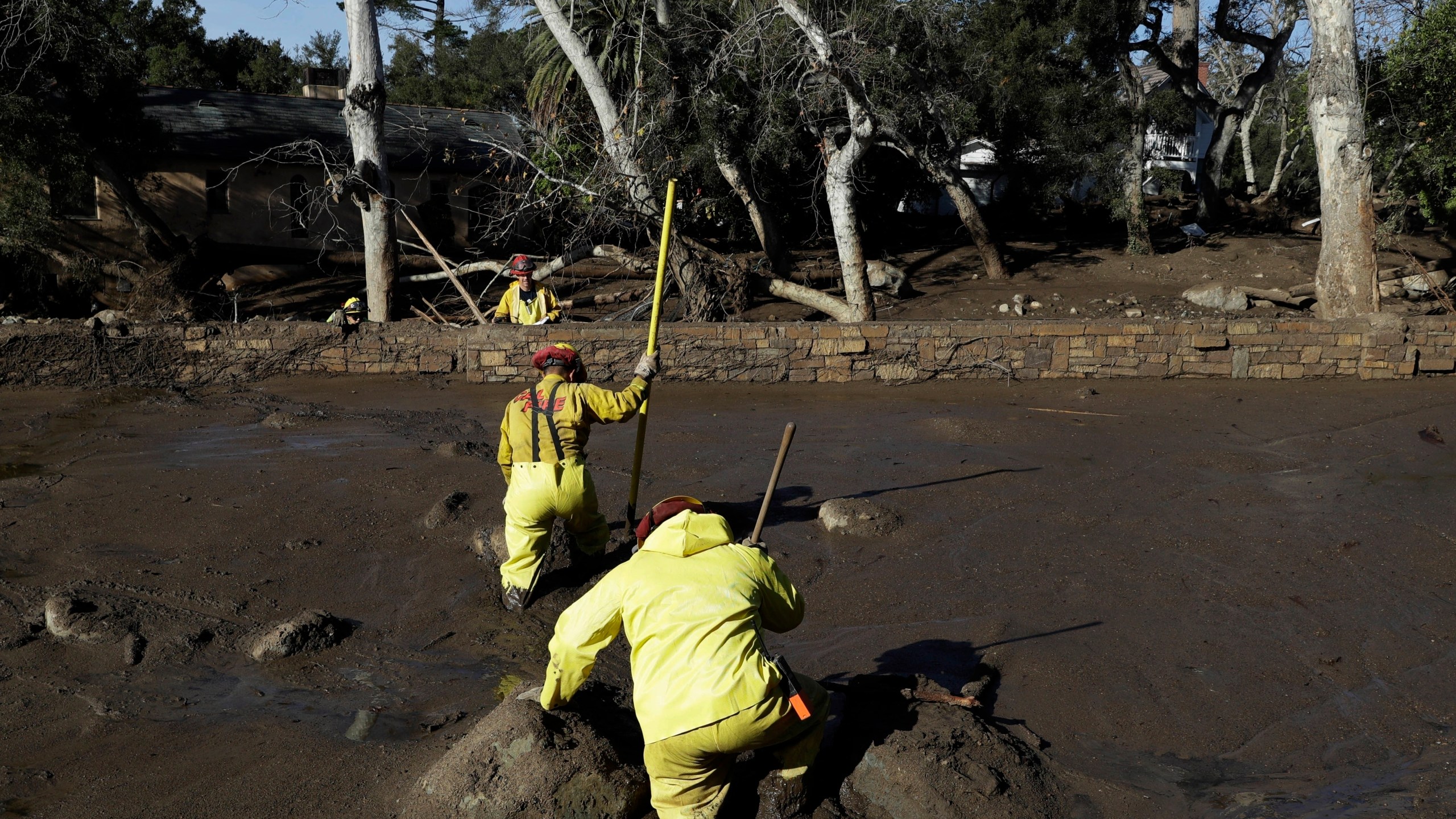 FILE - A Cal Fire search and rescue crew walks through mud near homes damaged by storms in Montecito, Calif., Jan. 12, 2018. (AP Photo/Marcio Jose Sanchez, File)