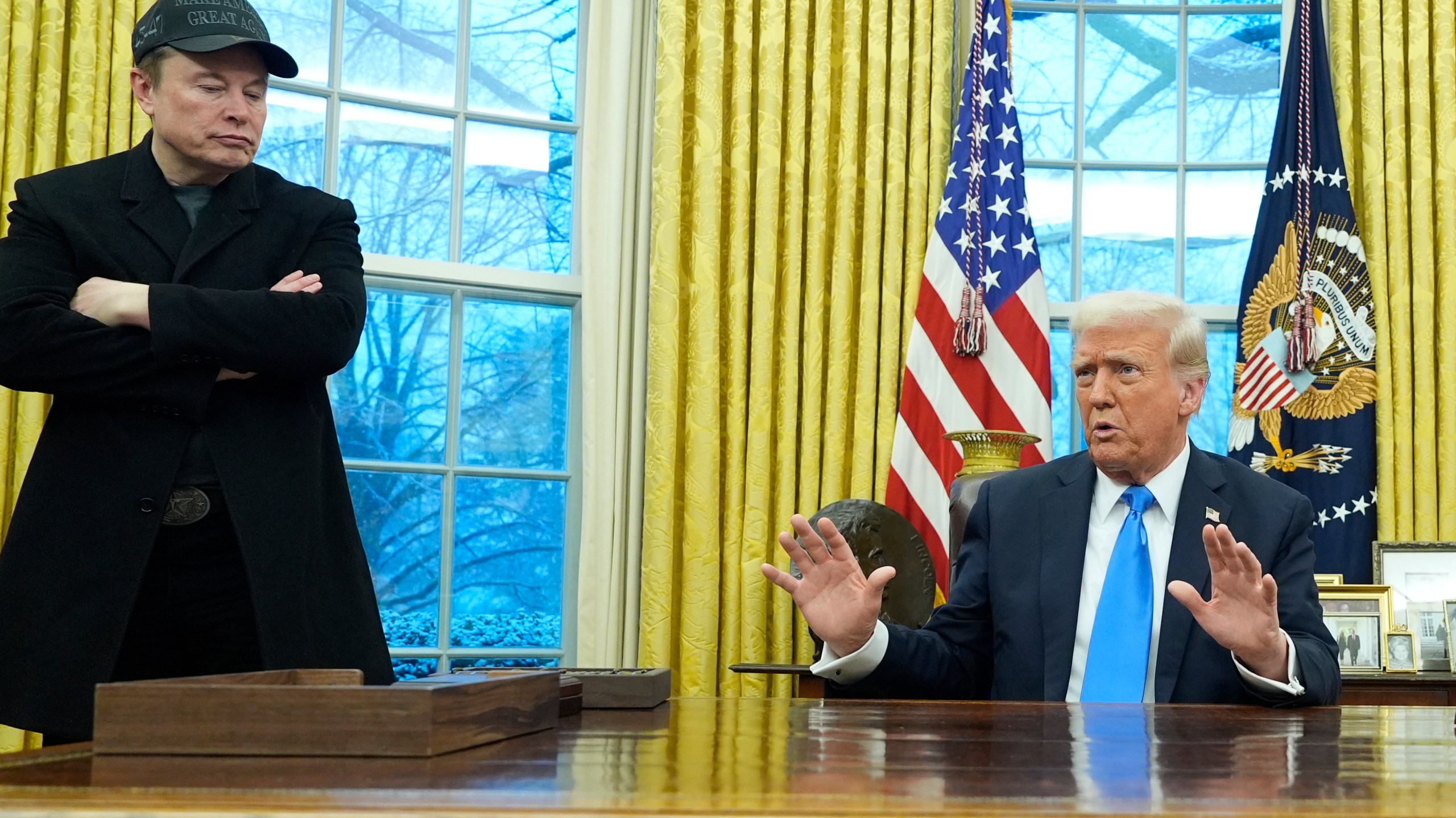 President Donald Trump speaks with reporters as Elon Musk listens in the Oval Office at the White House, Tuesday, Feb. 11, 2025, in Washington. (Photo/Alex Brandon)