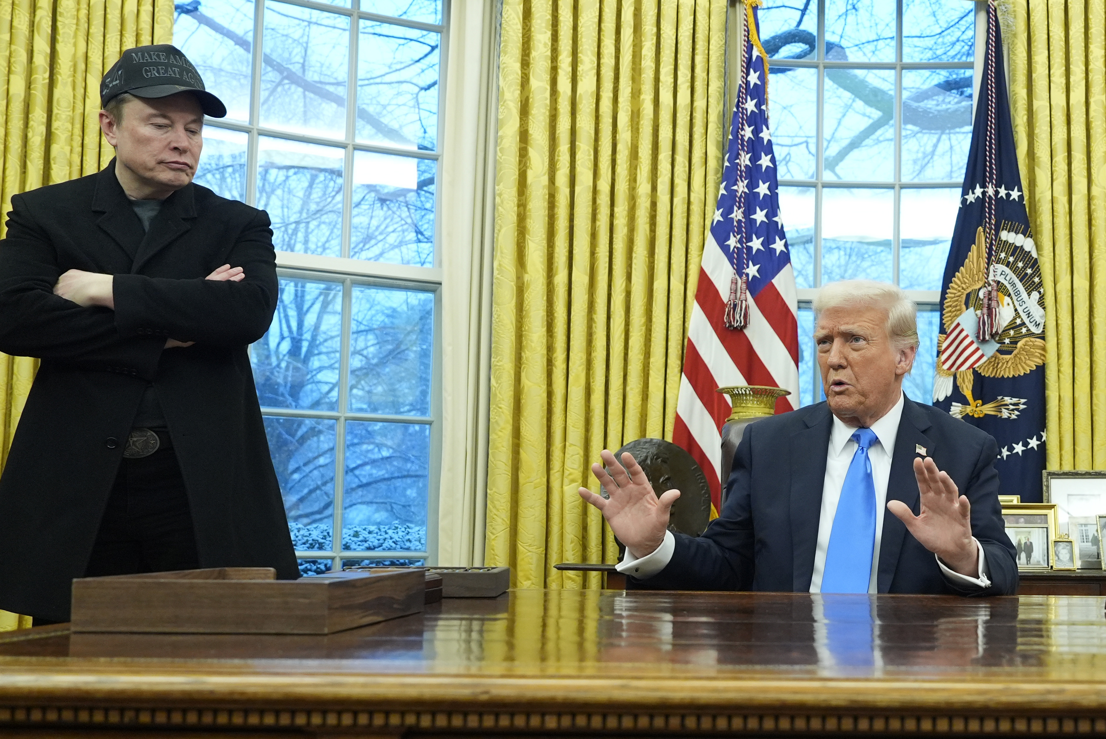 President Donald Trump speaks with reporters as Elon Musk listens in the Oval Office at the White House, Tuesday, Feb. 11, 2025, in Washington. (Photo/Alex Brandon)