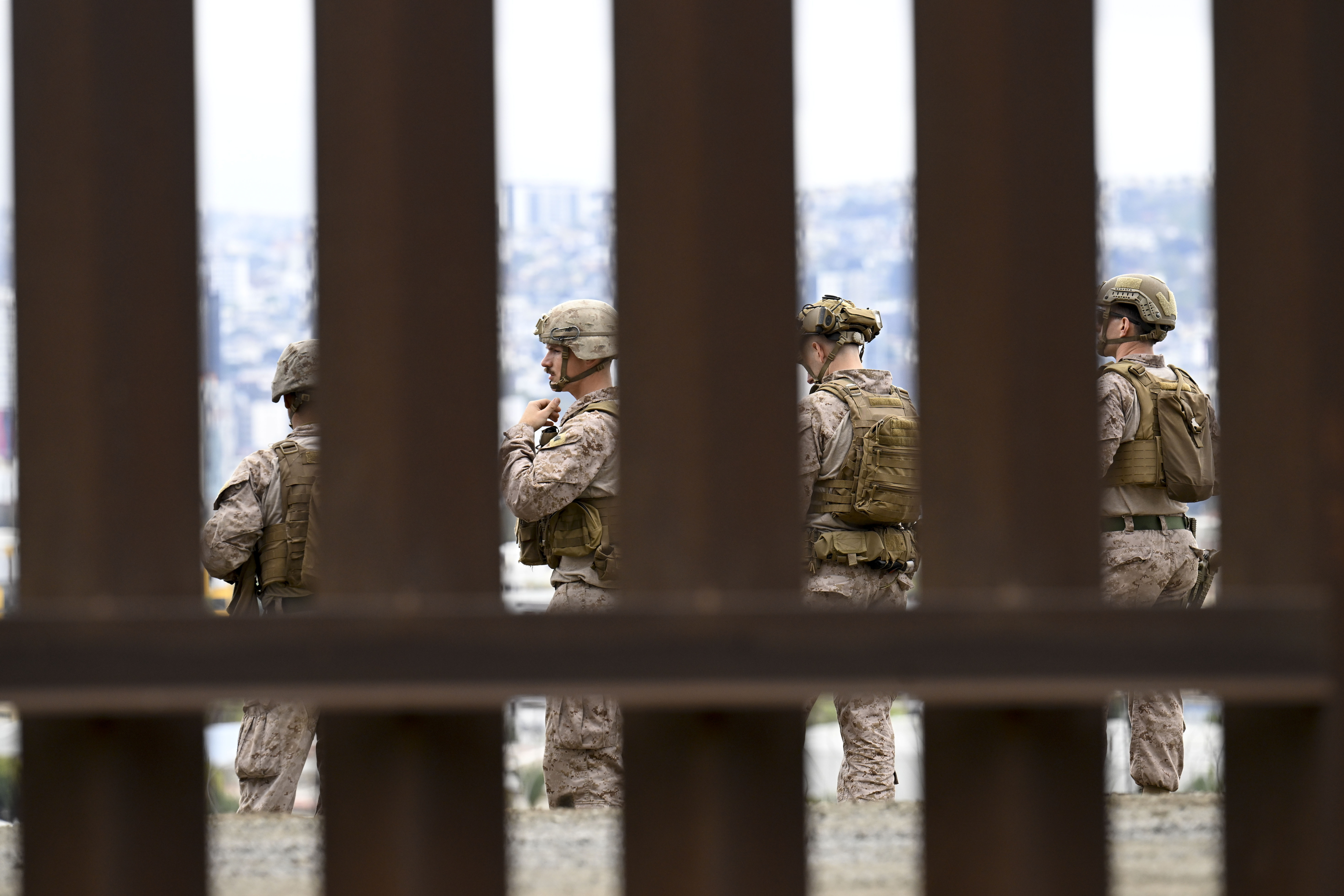 U.S. Marines deploy along the U.S.-Mexico border near the San Ysidro Port of Entry, Friday, Feb. 7, 2025, in San Diego. Tijuana, Mexico in seen in the background. (AP Photo/Denis Poroy)