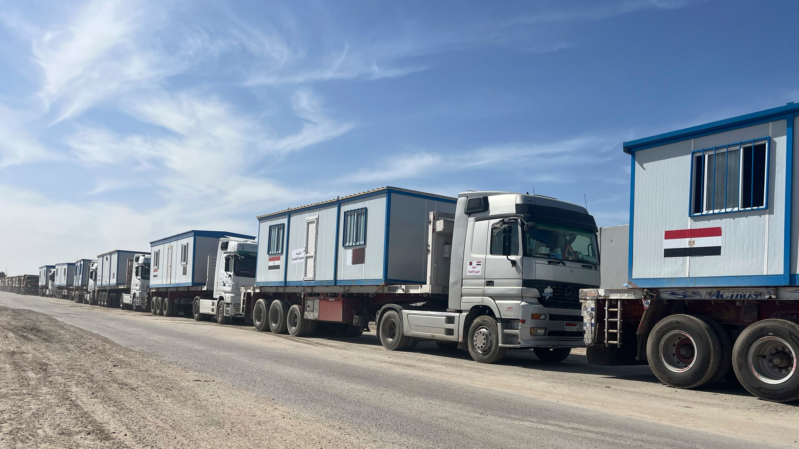 Scores of trucks carrying mobile homes line up on the Egyptian side of the Rafah crossing in preparation for entering Gaza, at the Rafah border crossing, Egypt, Tuesday, Feb. 18, 2025. (AP Photo/Mayar Mokhtar)