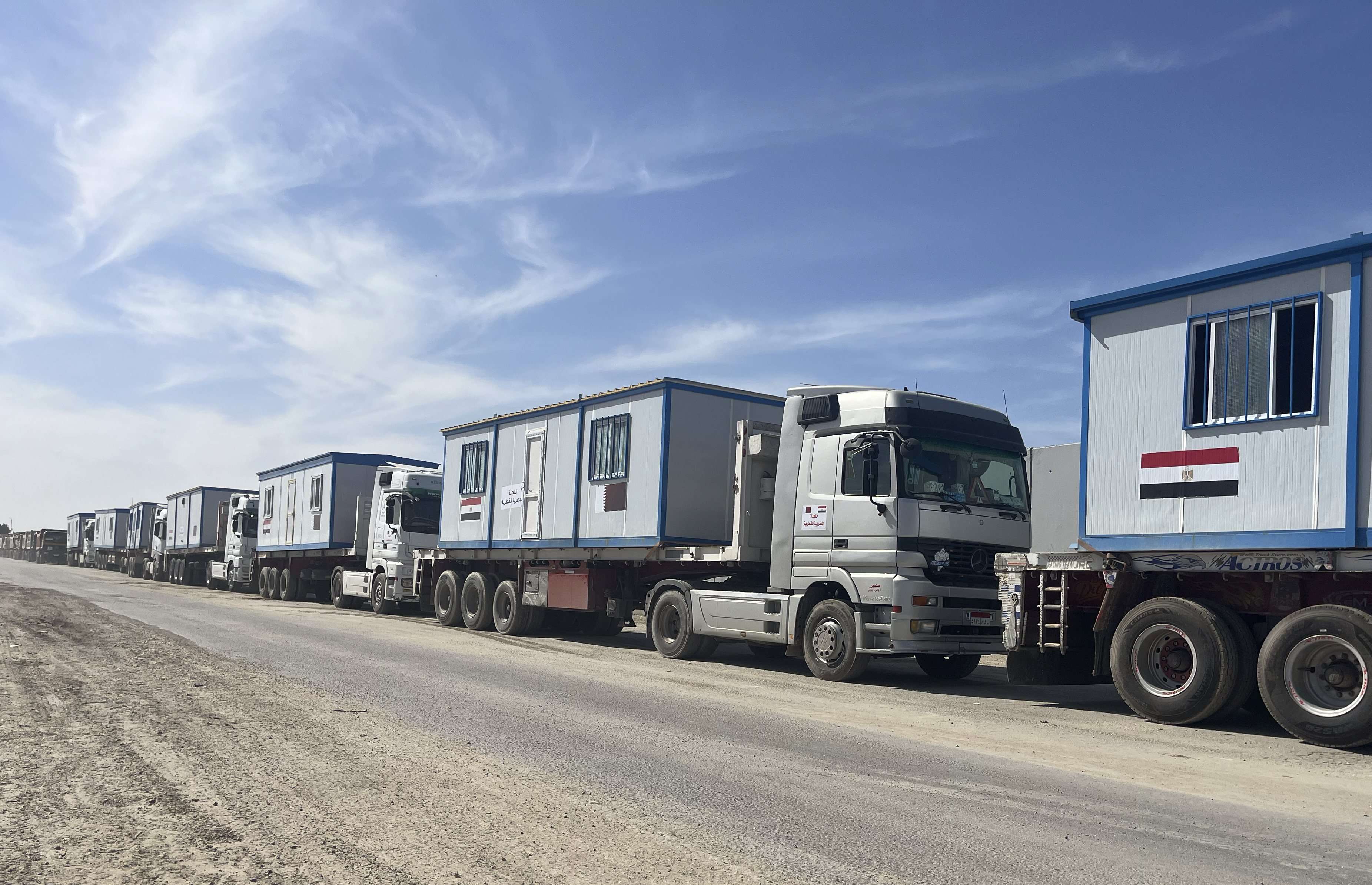 Scores of trucks carrying mobile homes line up on the Egyptian side of the Rafah crossing in preparation for entering Gaza, at the Rafah border crossing, Egypt, Tuesday, Feb. 18, 2025. (AP Photo/Mayar Mokhtar)