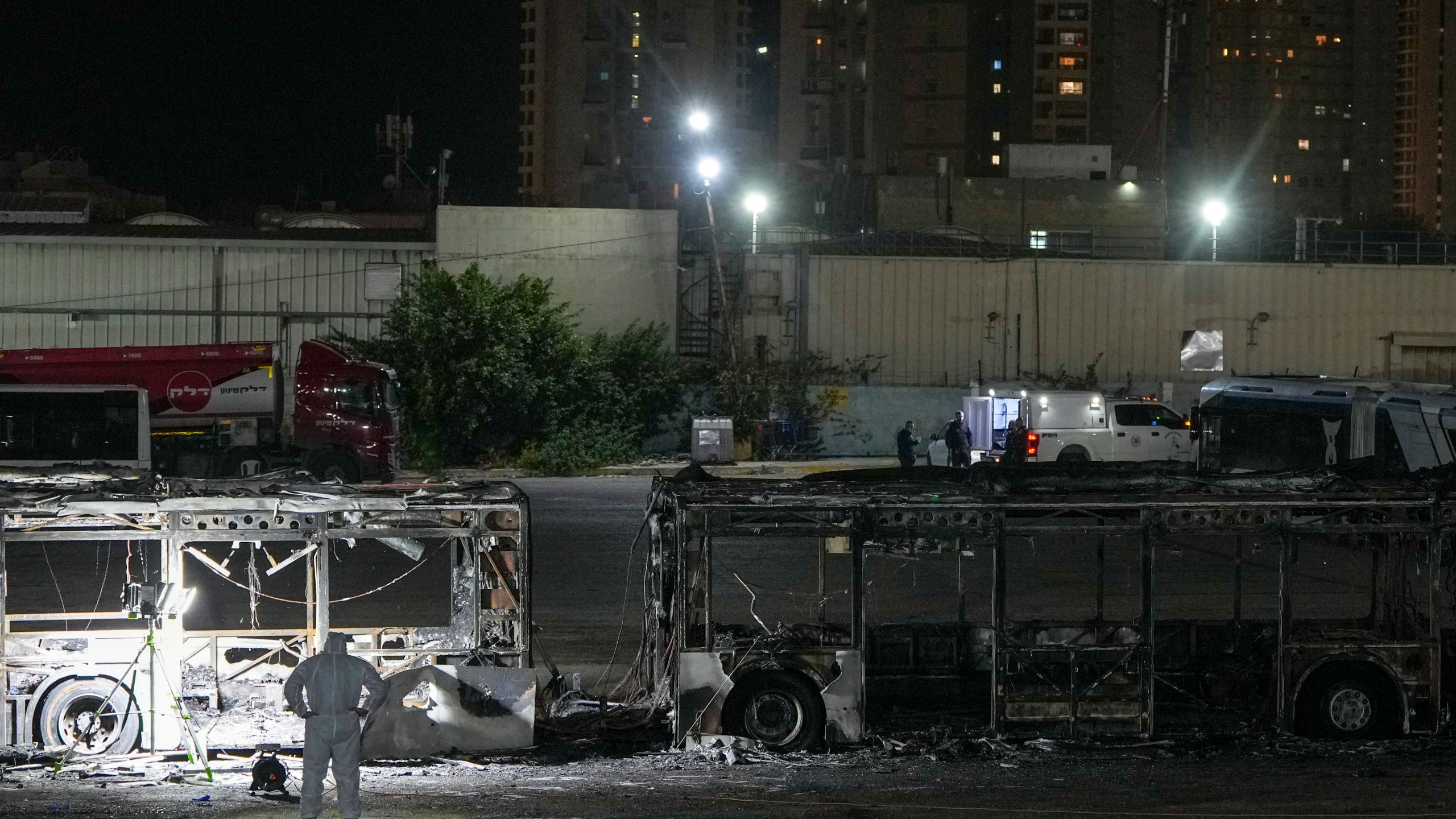 Israeli police inspect the scene of one of a series of bus explosions in what authorities said appeared to be a militant attack in Bat Yam, central Israel, Thursday, Feb. 20, 2025. (AP Photo/Ohad Zwigenberg)