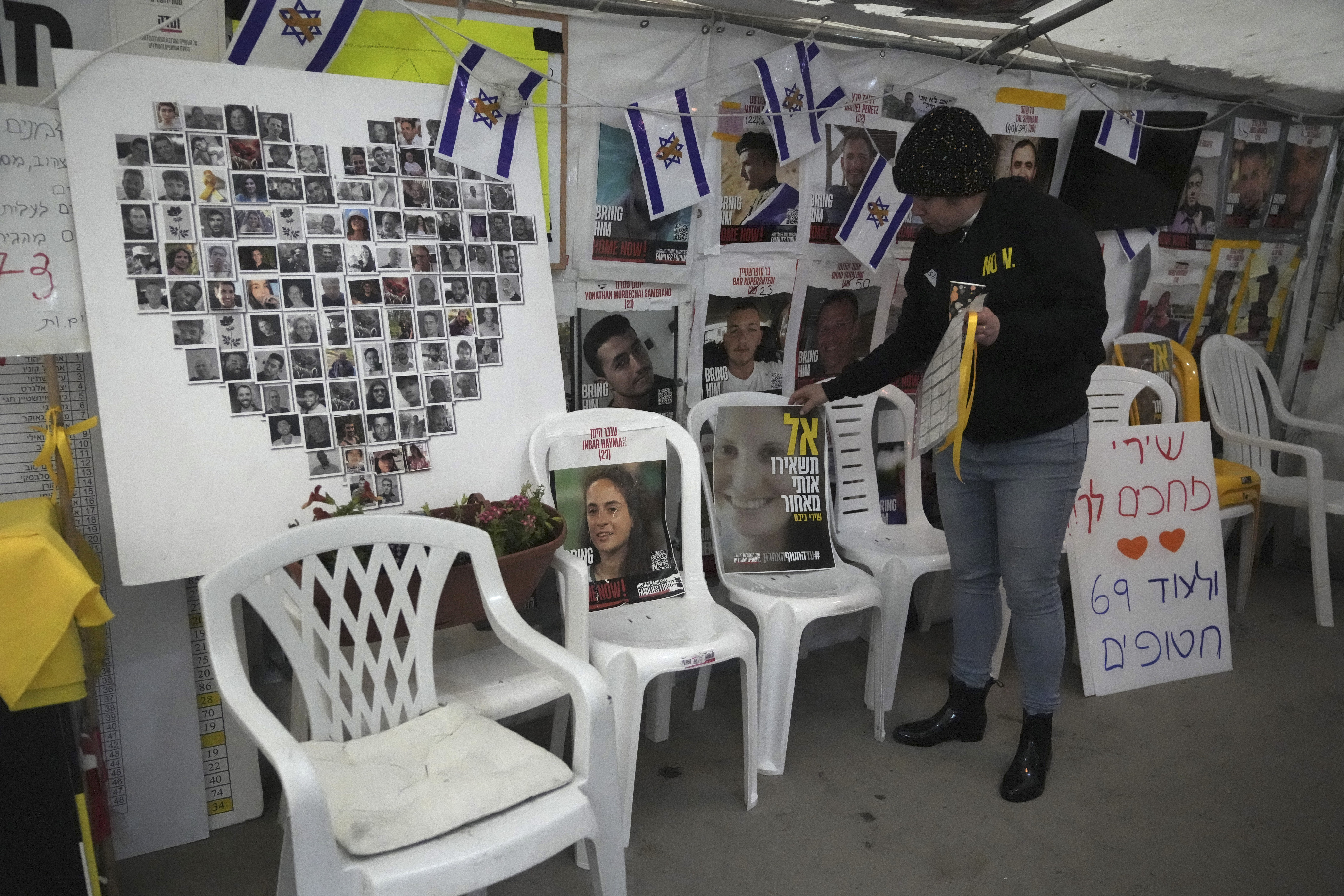 A poster shows Shiri Bibas, center, who was kidnapped to Gaza with her husband and two young sons on Oct. 7, 2023, in Jerusalem, Friday, Feb. 21, 2025. (AP Photo/Mahmoud Illean)