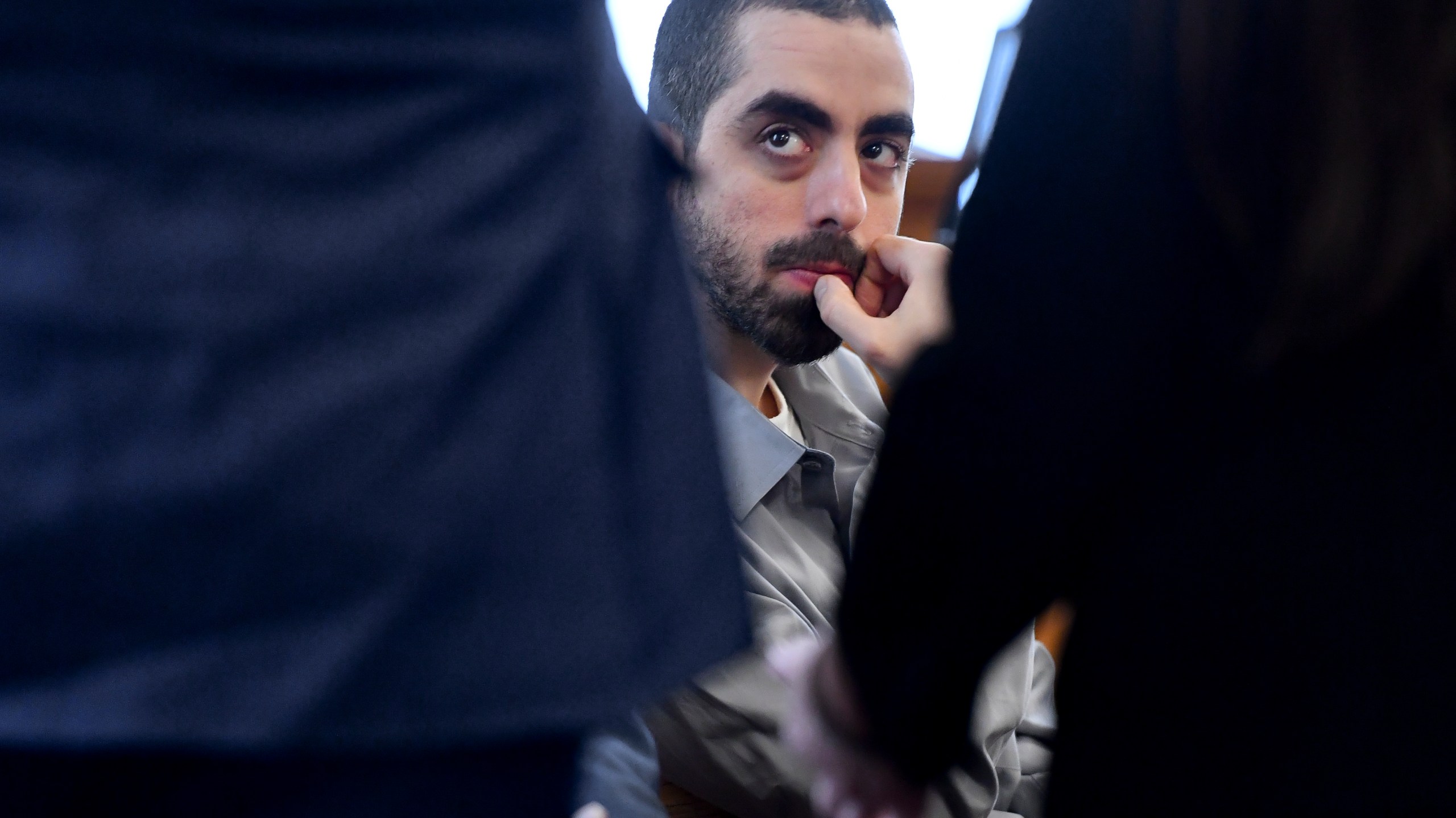 Hadi Matar, charged with severely injuring author Salman Rushdie in a 2022 knife attack, listens to his defense team in Chautauqua County court in Mayville, N.Y., Thursday, Feb. 20, 2025. (AP Photo/Adrian Kraus)