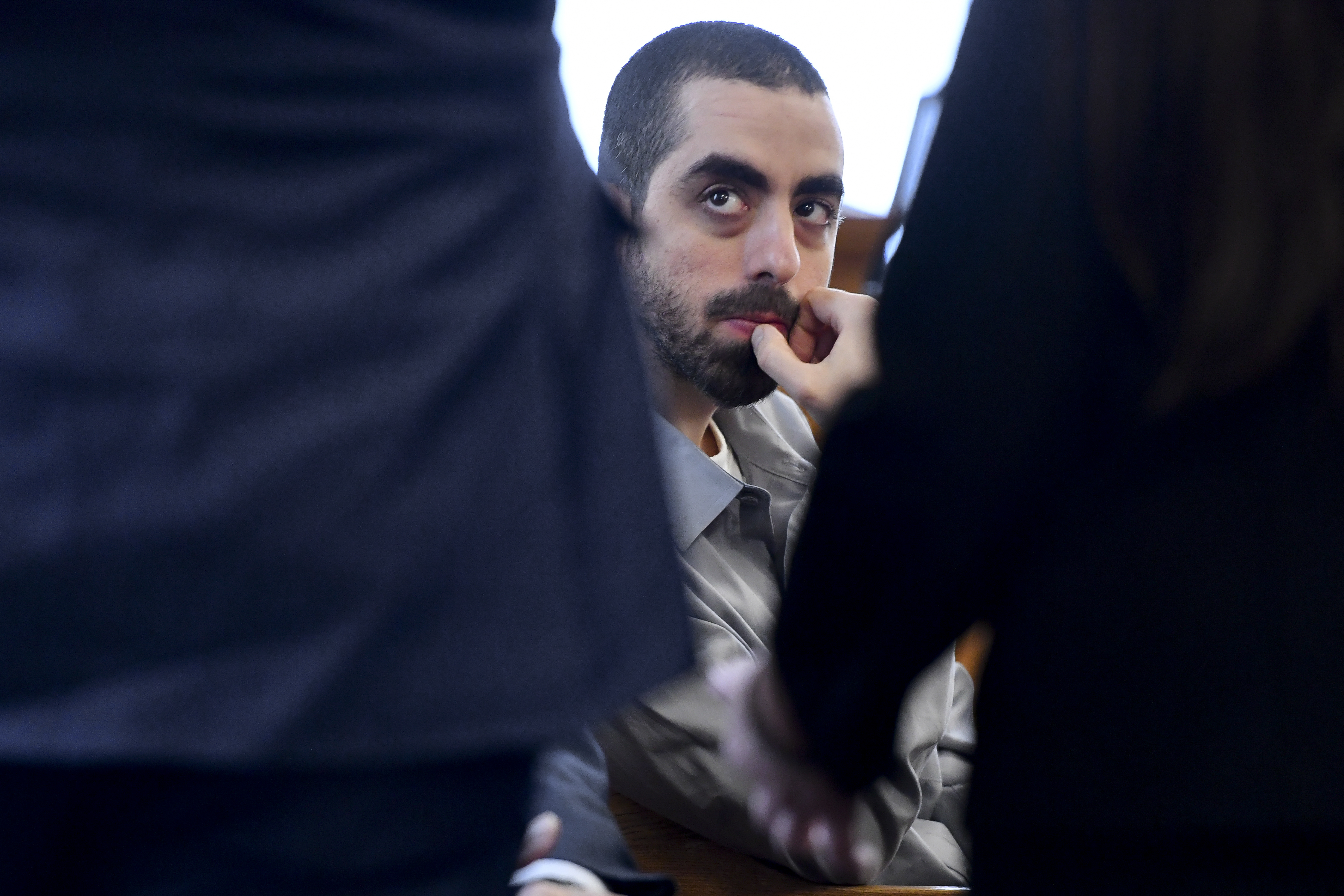 Hadi Matar, charged with severely injuring author Salman Rushdie in a 2022 knife attack, listens to his defense team in Chautauqua County court in Mayville, N.Y., Thursday, Feb. 20, 2025. (AP Photo/Adrian Kraus)