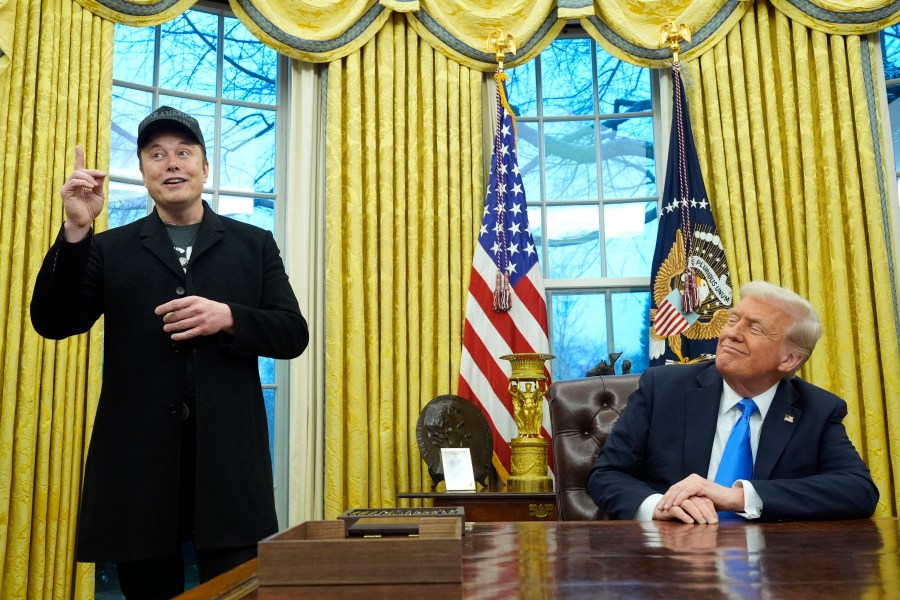 President Donald Trump listens as Elon Musk speaks in the Oval Office at the White House, Tuesday, Feb. 11, 2025, in Washington. (AP Photo/Alex Brandon)