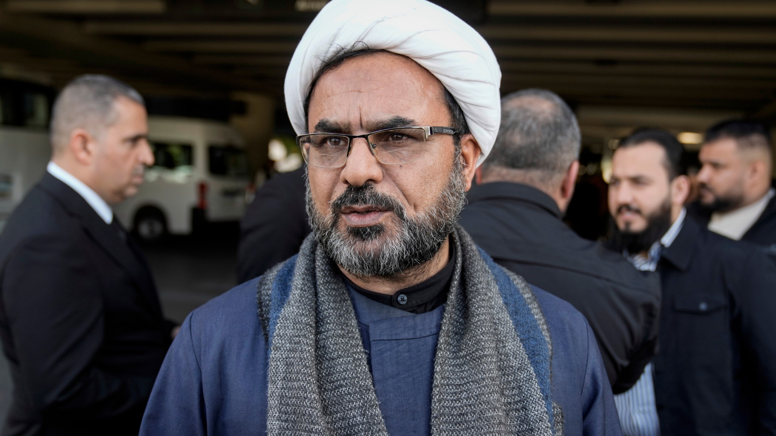 Sheikh Kazim al-Fartousi, spokesman for the Iran-backed Kataib Sayyid al-Shuhada, speaks during an interview with The Associated Press upon his arrival at the Rafik Hariri International Airport, in Beirut, Lebanon, Friday, Feb. 21, 2025. (AP Photo/Bilal Hussein)