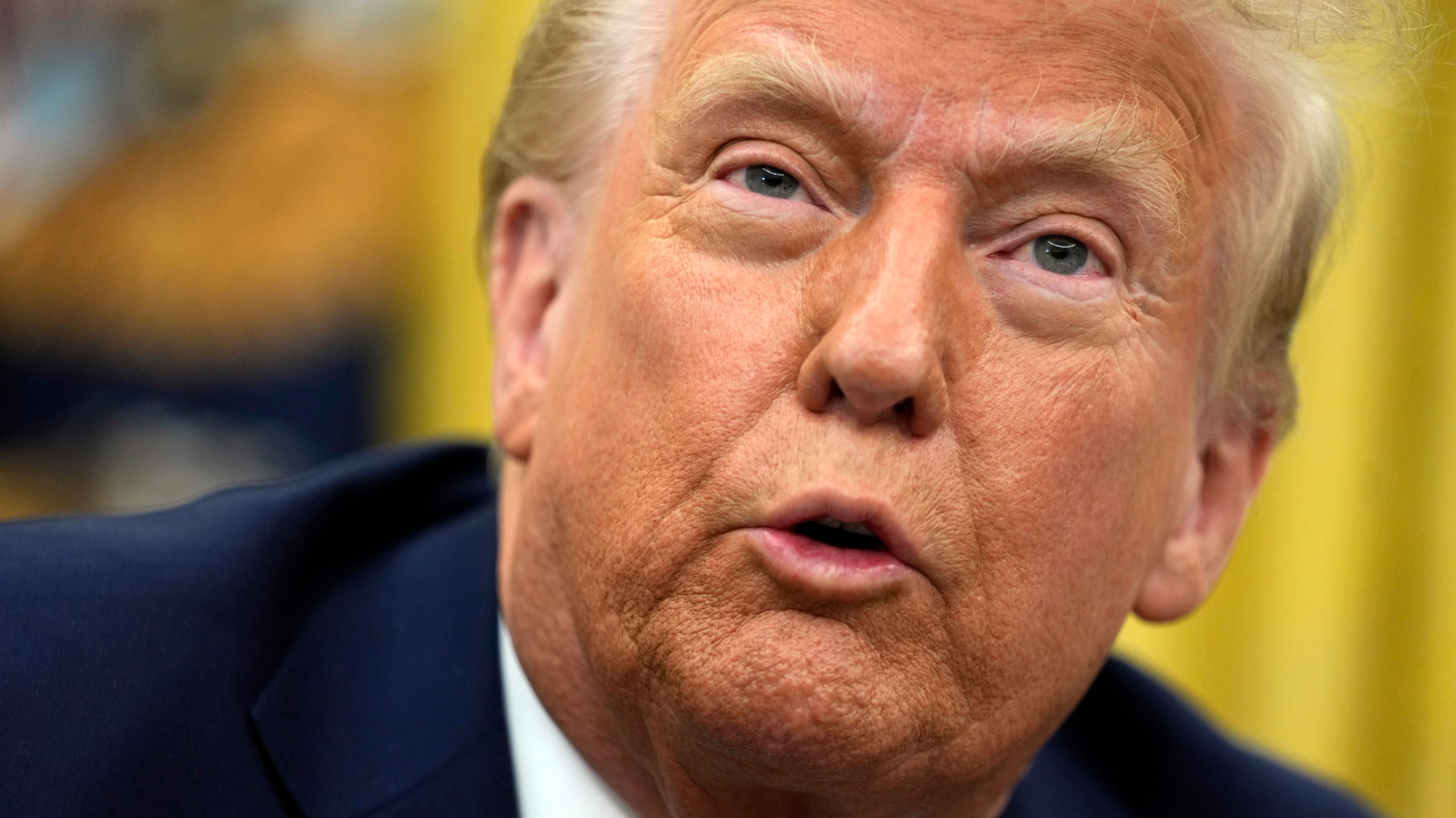 President Donald Trump talks to reporters as he signs executive orders in the Oval Office of the White House, Thursday, Jan. 23, 2025, in Washington. (AP Photo/Ben Curtis)