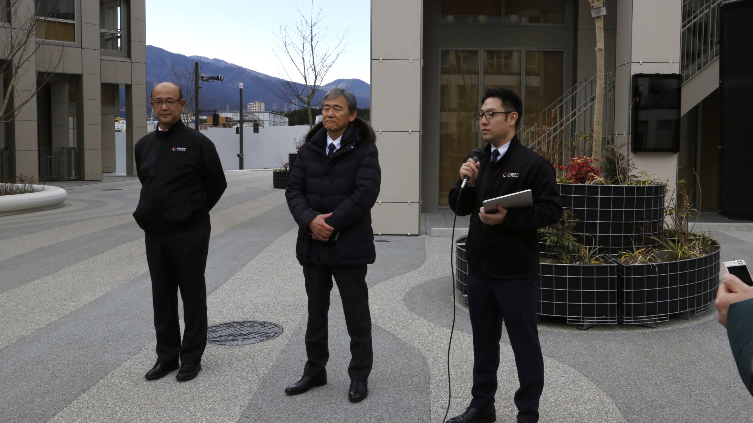 Toyota executives in charge of Woven City, from left to right, Woven by Toyota CFO Kenta Kon, CEO Hajime Kumabe and Head of Woven City Management Daisuke Toyoda speak to reporters about the first phase construction of the project in Susono, Japan Feb. 22, 2025. (AP Photo/Yuri Kageyama)