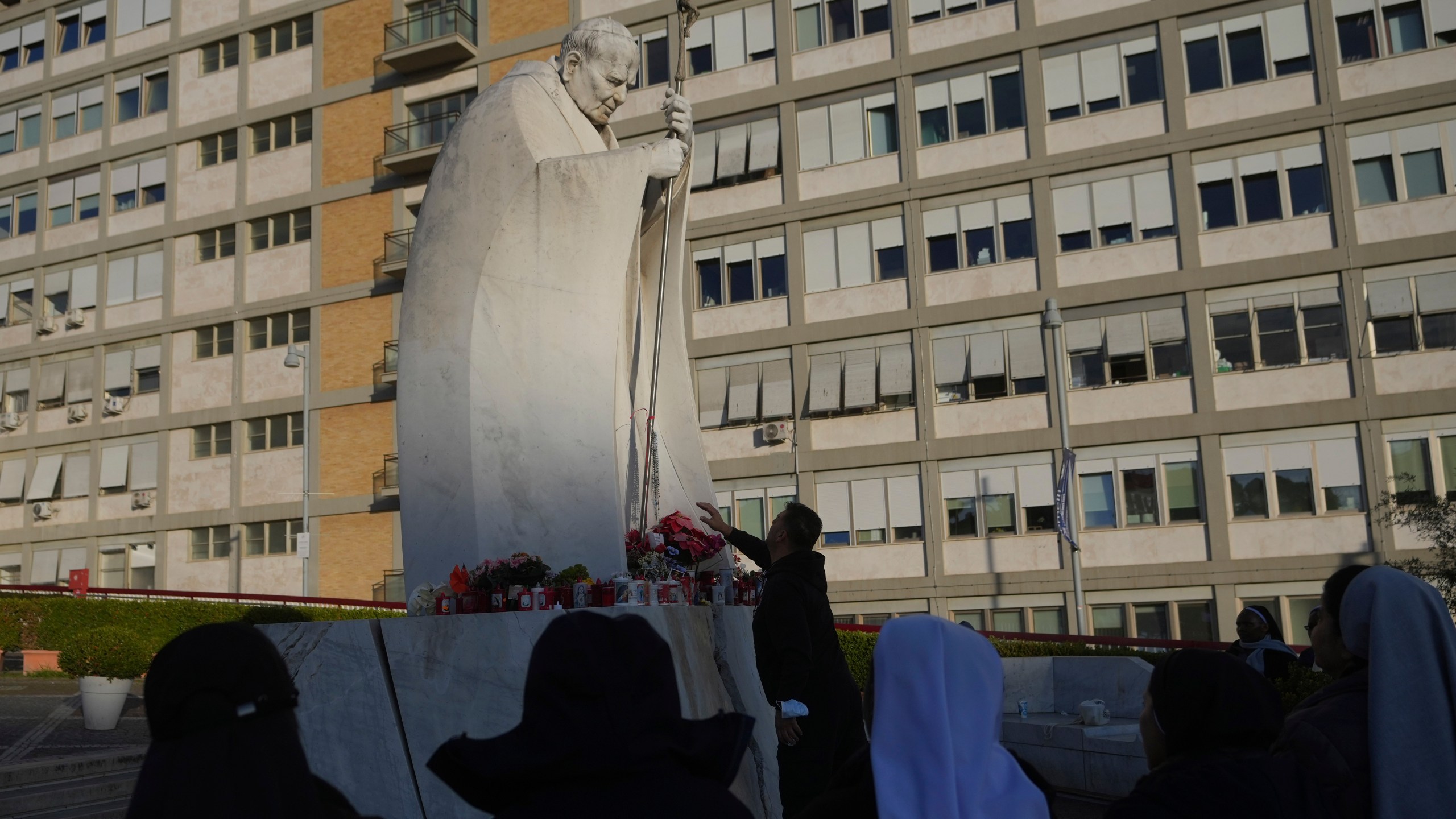 Nuns pray for Pope Francis in front of the Agostino Gemelli Polyclinic, in Rome, Saturday, Feb. 22, 2025, where the Pontiff has been hospitalized since Friday, Feb. 14. (AP Photo/Alessandra Tarantino)