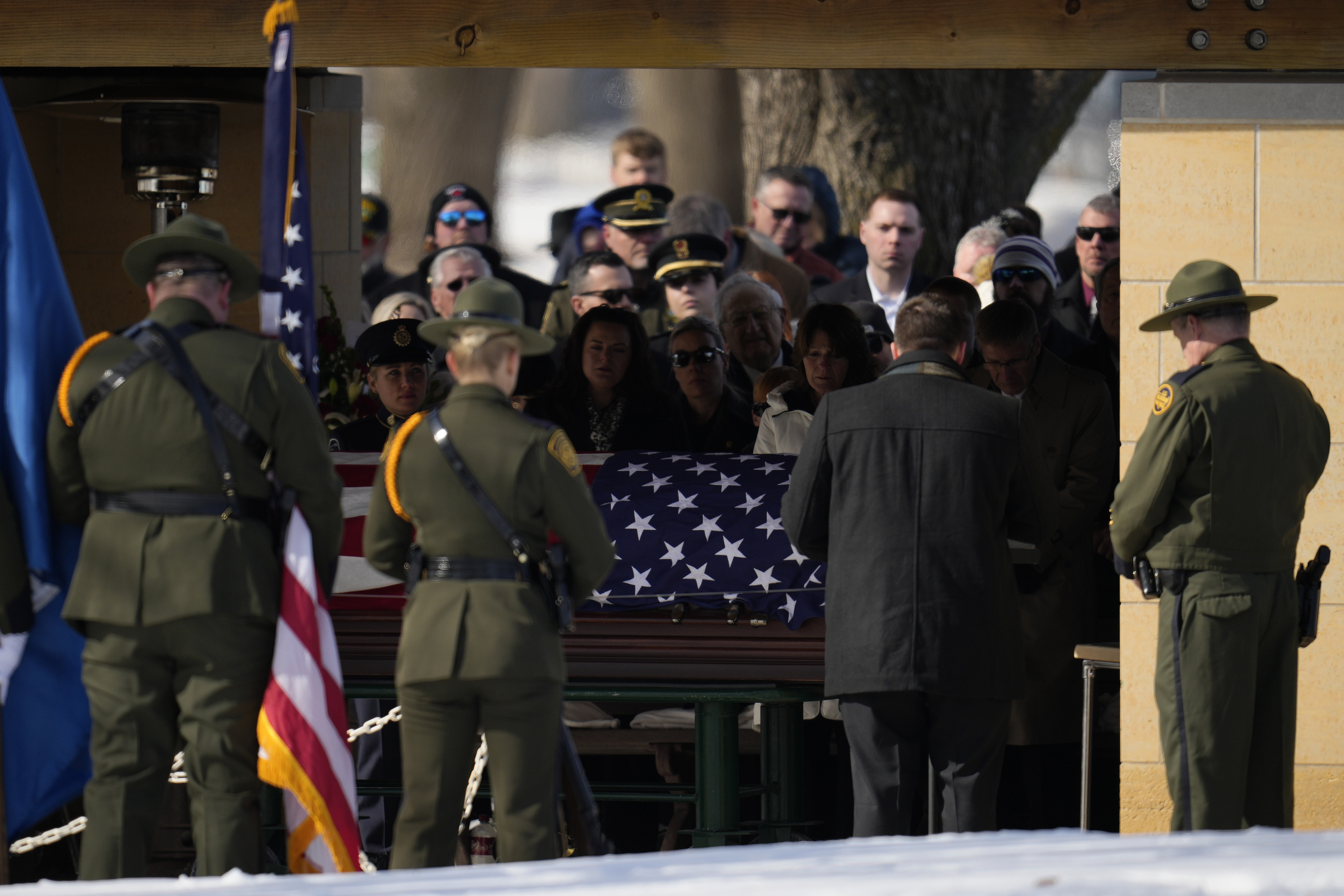 U.S. Border Patrol agent David Maland is recognized with military honors before his burial at Fort Snelling National Cemetery in Minneapolis, on Saturday, Feb. 22, 2025. (AP Photo/Abbie Parr)