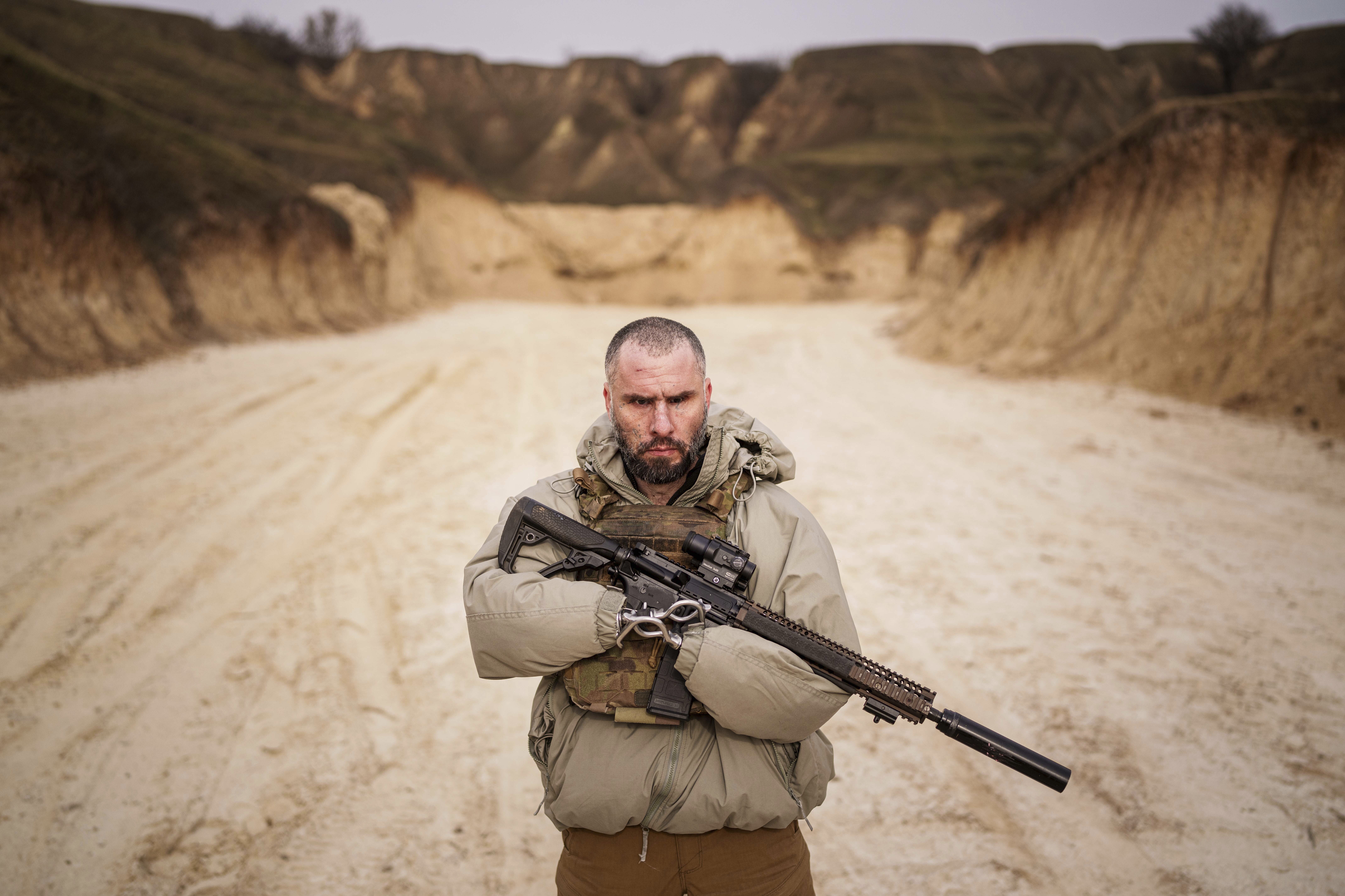 Andrii Rubliuk, a senior sergeant with a Ukrainian intelligence unit who lost both arms and a leg in combat, holds a rifle during military training near Kyiv, Ukraine, on Feb. 14, 2025. (AP Photo/Evgeniy Maloletka)