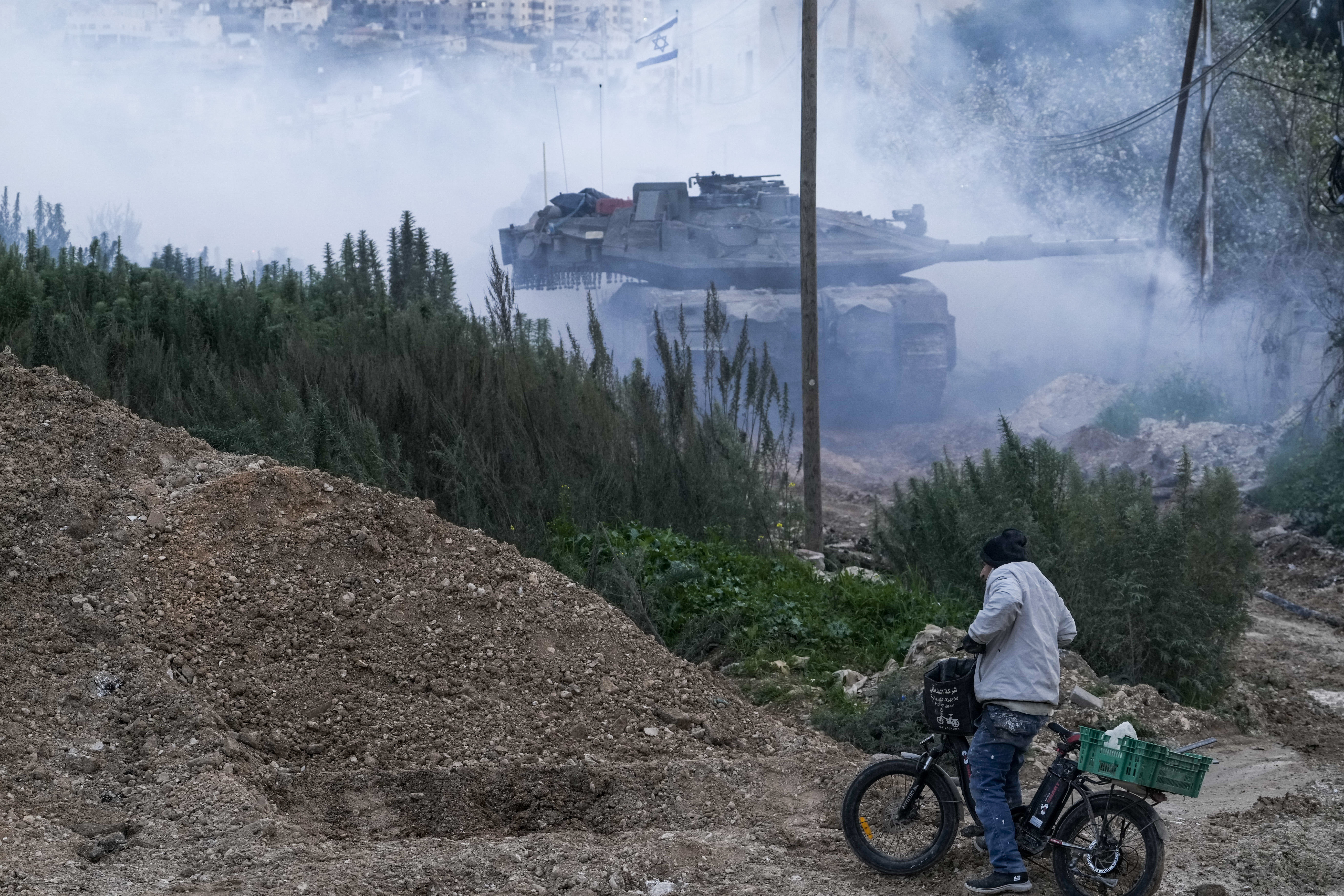 Israeli tanks moving into the Palestinians city of Jenin in the occupied West Bank, Sunday, Feb. 23, 2025. (AP Photo/Majdi Mohammed)