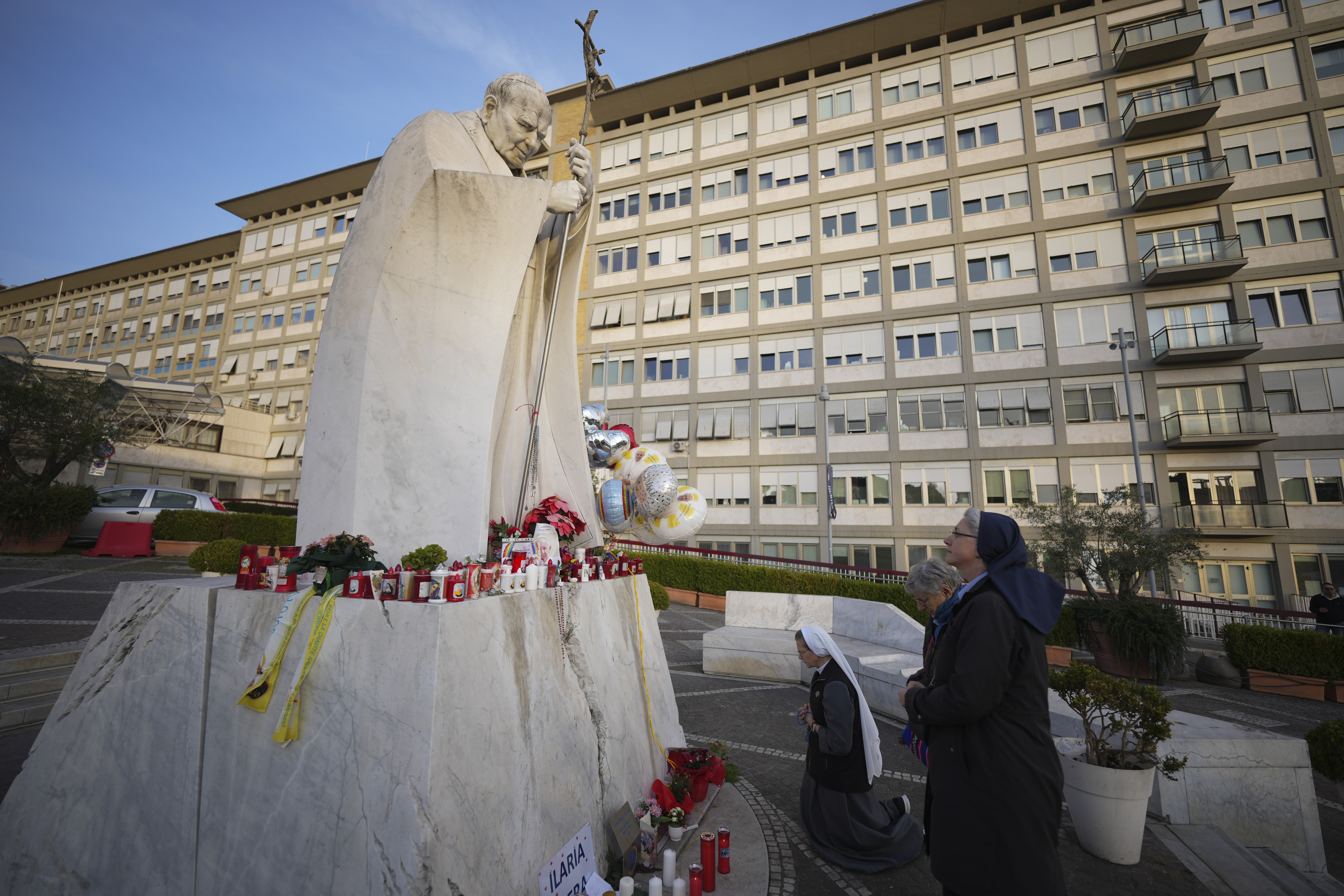 Nuns pray for Pope Francis in front of the Agostino Gemelli Polyclinic, in Rome, Sunday, Feb. 23, 2025, where the Pontiff has been hospitalized since Friday, Feb. 14. (AP Photo/Andrew Medichini)