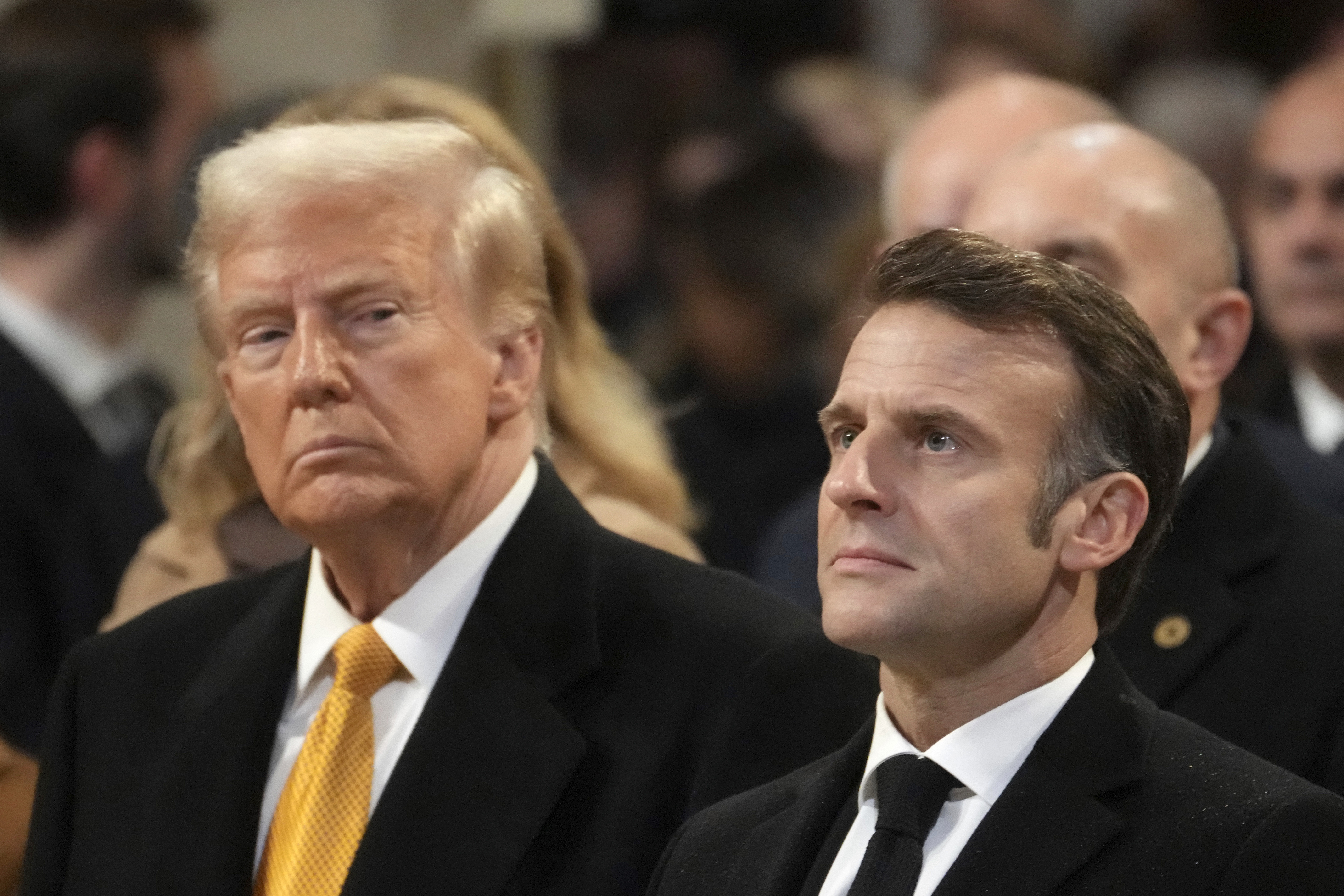 FILE - President-elect Donal Trump looks at France's President Emmanuel Macron in Notre Dame Cathedral, Dec. 7, 2024, in Paris. (AP Photo/Thibault Camus, Pool, File)