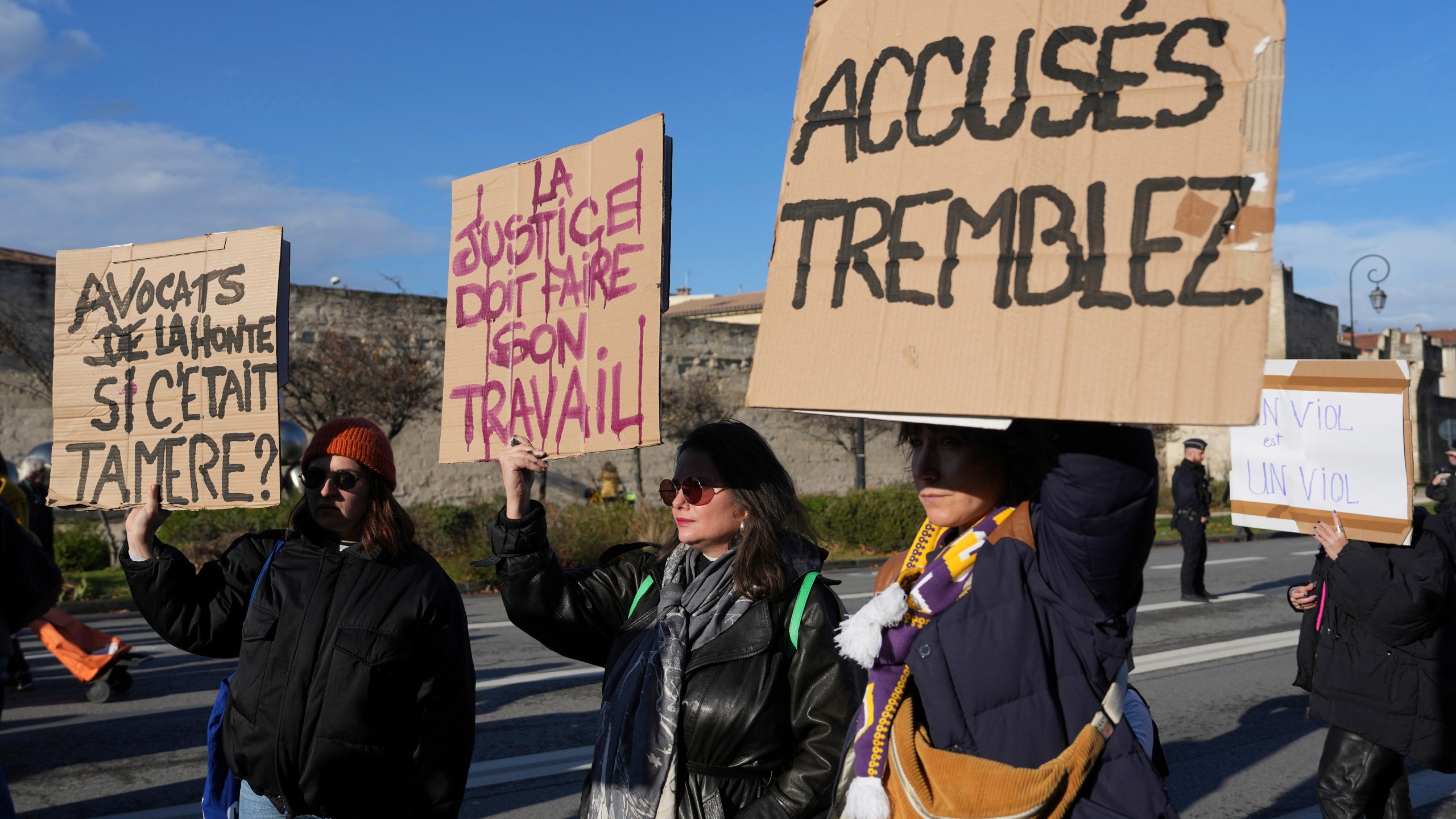 FILE -Activists hold posters during a women's rights demonstration, Dec. 14, 2024 in Avignon, southern France, where the trial of dozens of men accused of raping Gisèle Pelicot while she was drugged and rendered unconscious by her husband is taking place. (AP Photo/Aurelien Morissard), File)