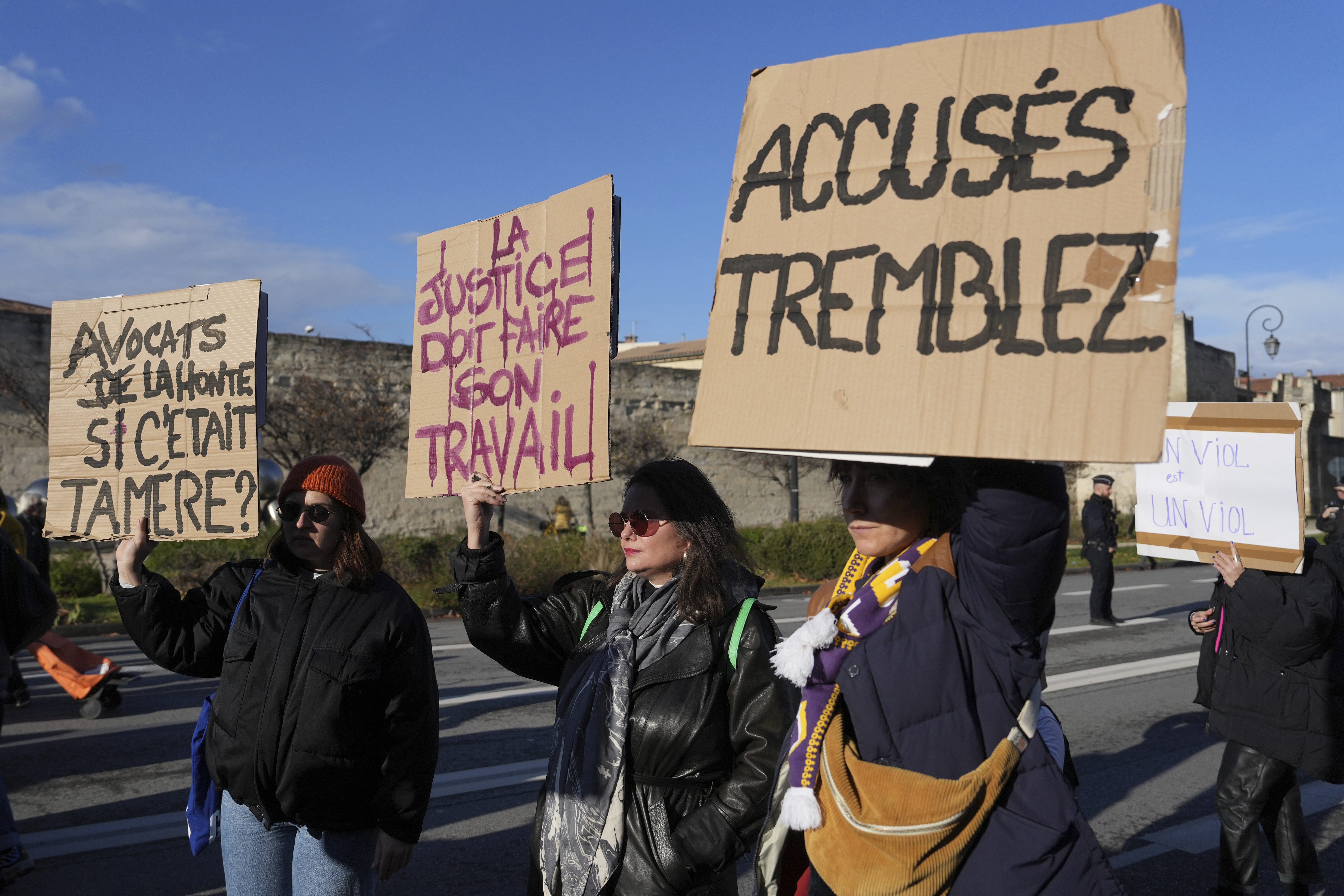 FILE -Activists hold posters during a women's rights demonstration, Dec. 14, 2024 in Avignon, southern France, where the trial of dozens of men accused of raping Gisèle Pelicot while she was drugged and rendered unconscious by her husband is taking place. (AP Photo/Aurelien Morissard), File)