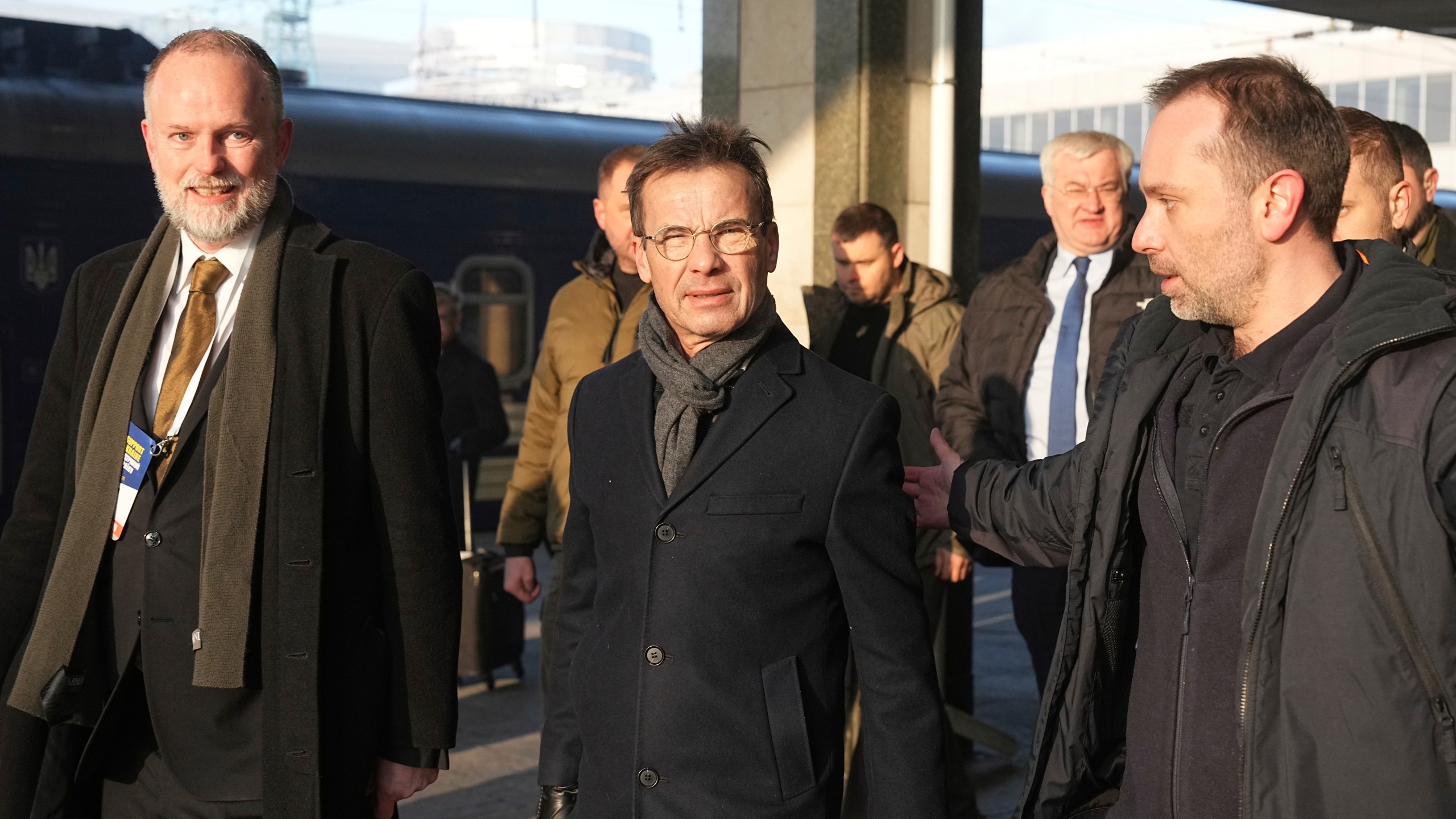 Sweden's Prime Minister Ulf Kristersson, center, arrives at a train station on the third anniversary of the Russian invasion of Ukraine, Kyiv, Ukraine, Monday, Feb. 24, 2025. (AP Photo/Efrem Lukatsky)