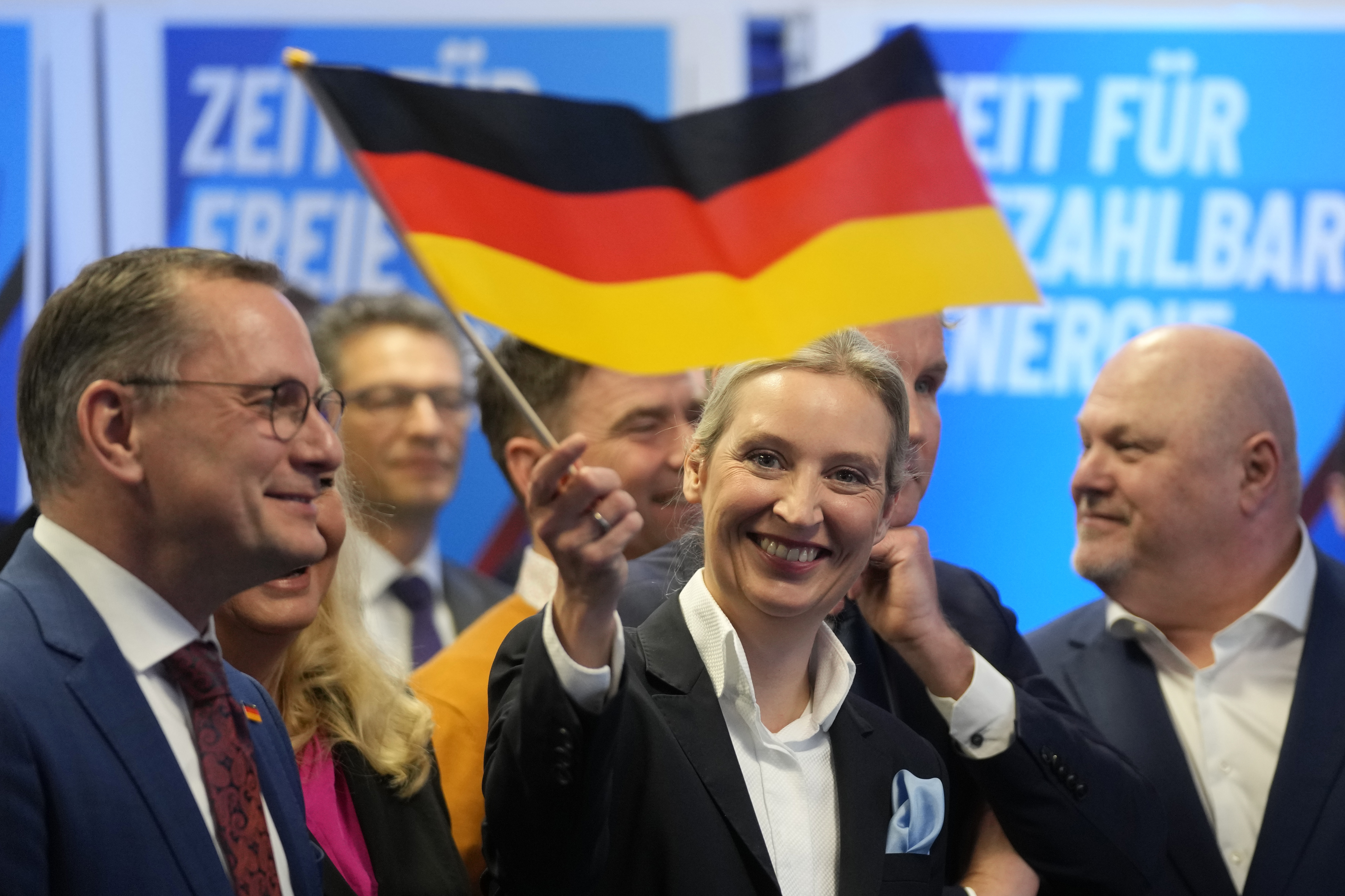 Leader of far right AfD Alice Weidel waves a German flag at the AfD party headquarters in Berlin, Germany, Sunday, Feb. 23, 2025, after the German national election. (AP Photo/Michael Probst)