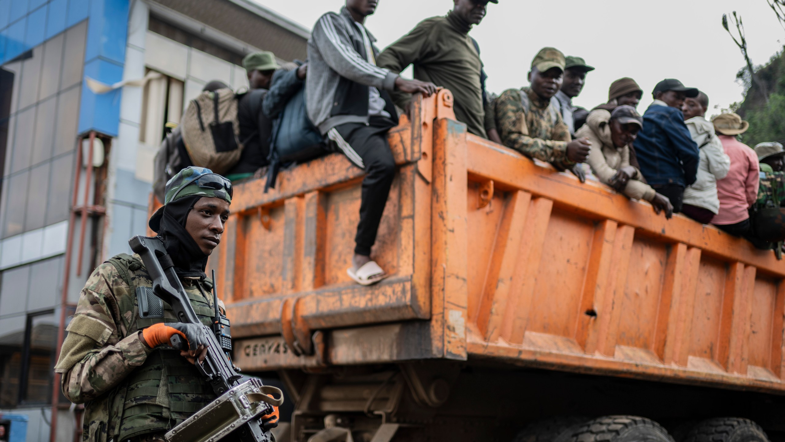 Former members of the Armed Forces of the Democratic Republic of Congo (FARDC) and police officers who allegedly surrendered to M23 rebels arrive in Goma, Congo, Sunday, Feb. 23, 2025. (AP Photo/Moses Sawasawa)