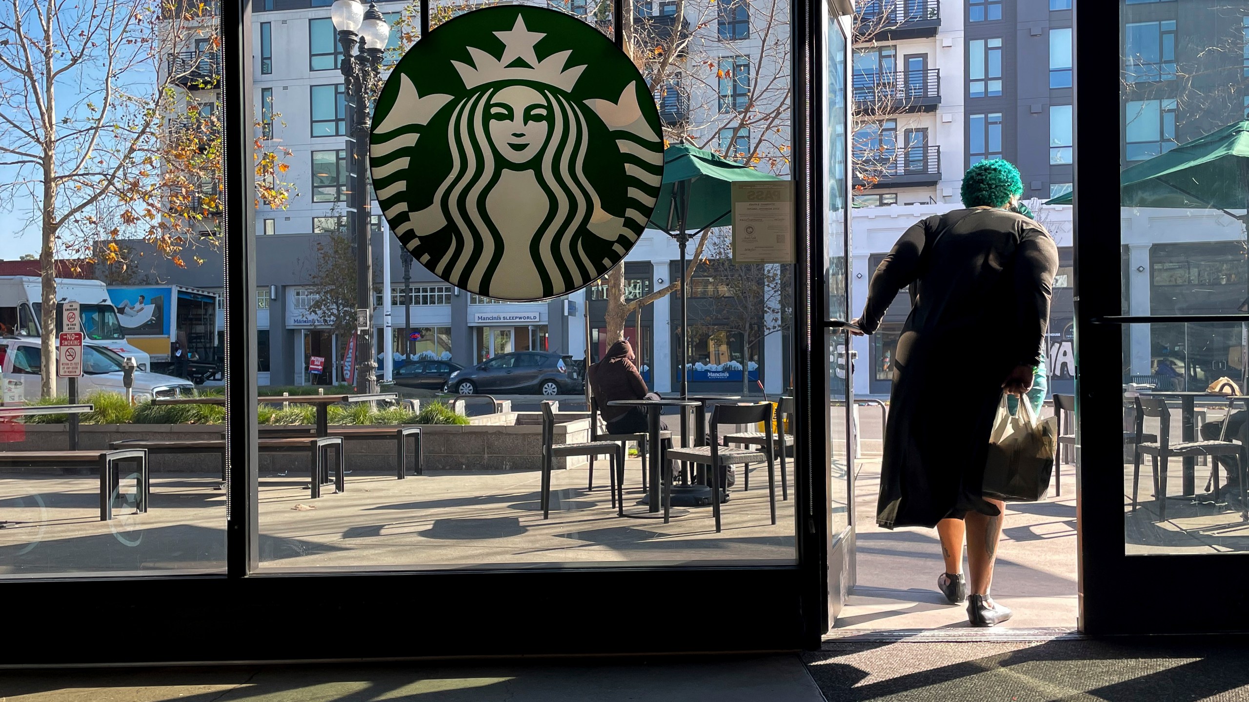 FILE - A costumer exits a Starbucks store in Oakland, Calif., Jan. 16, 2025. (AP Photo/Godofredo A. Vásquez, File)