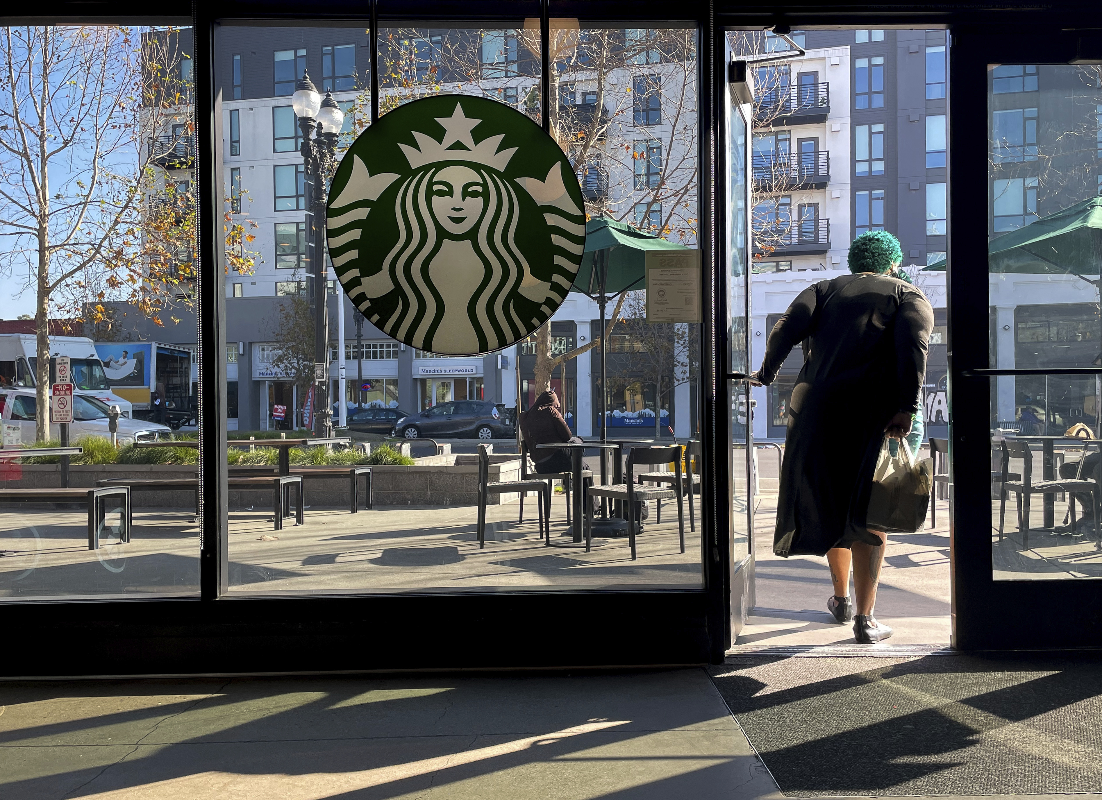 FILE - A costumer exits a Starbucks store in Oakland, Calif., Jan. 16, 2025. (AP Photo/Godofredo A. Vásquez, File)