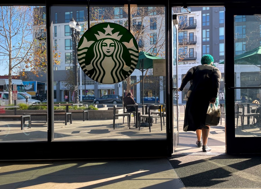 FILE - A costumer exits a Starbucks store in Oakland, Calif., Jan. 16, 2025. (AP Photo/Godofredo A. Vásquez, File)