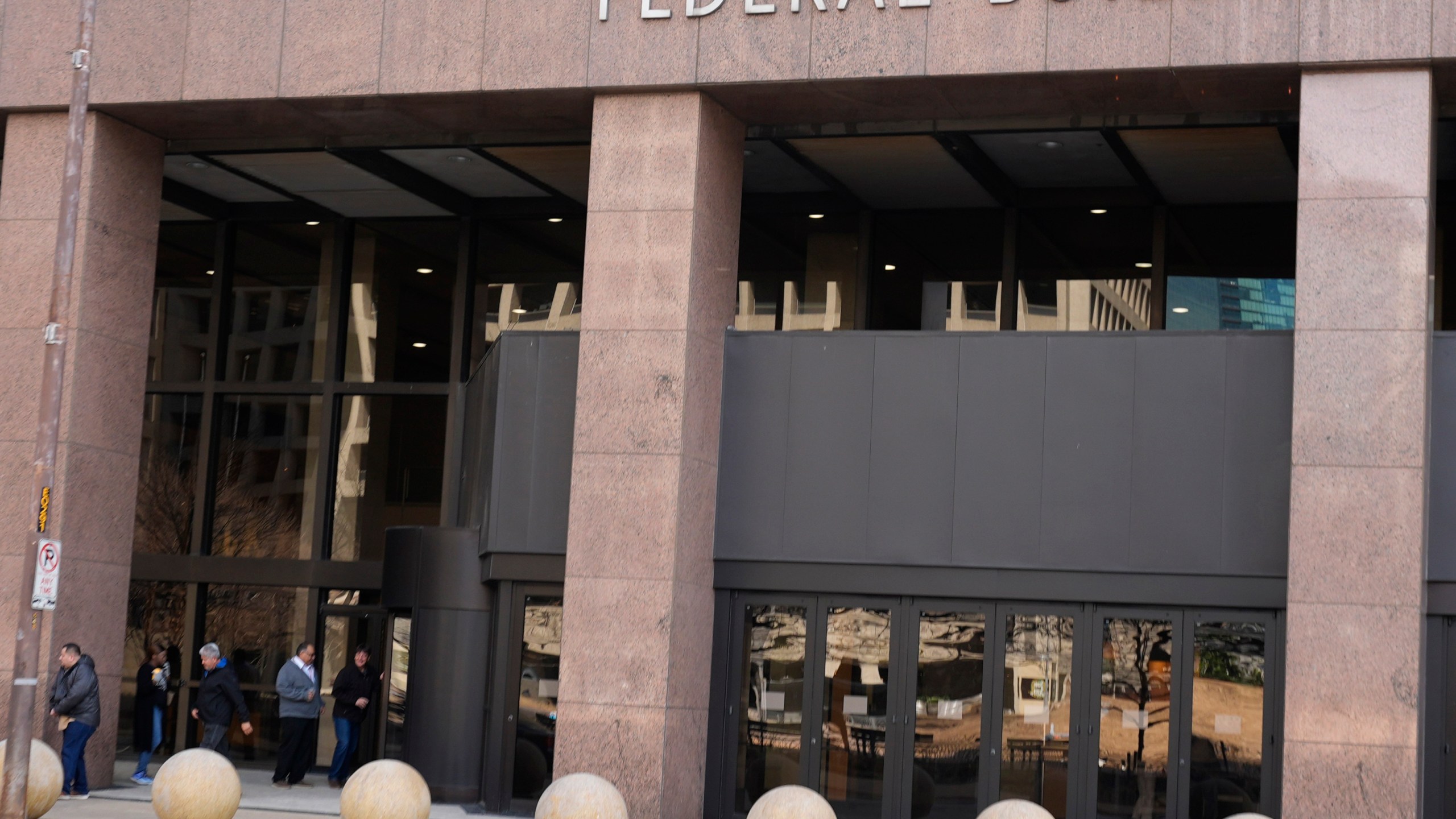 People enter the Earle Cabell Federal Building in downtown Dallas, Monday, Feb. 24, 2025. (AP Photo/LM Otero)