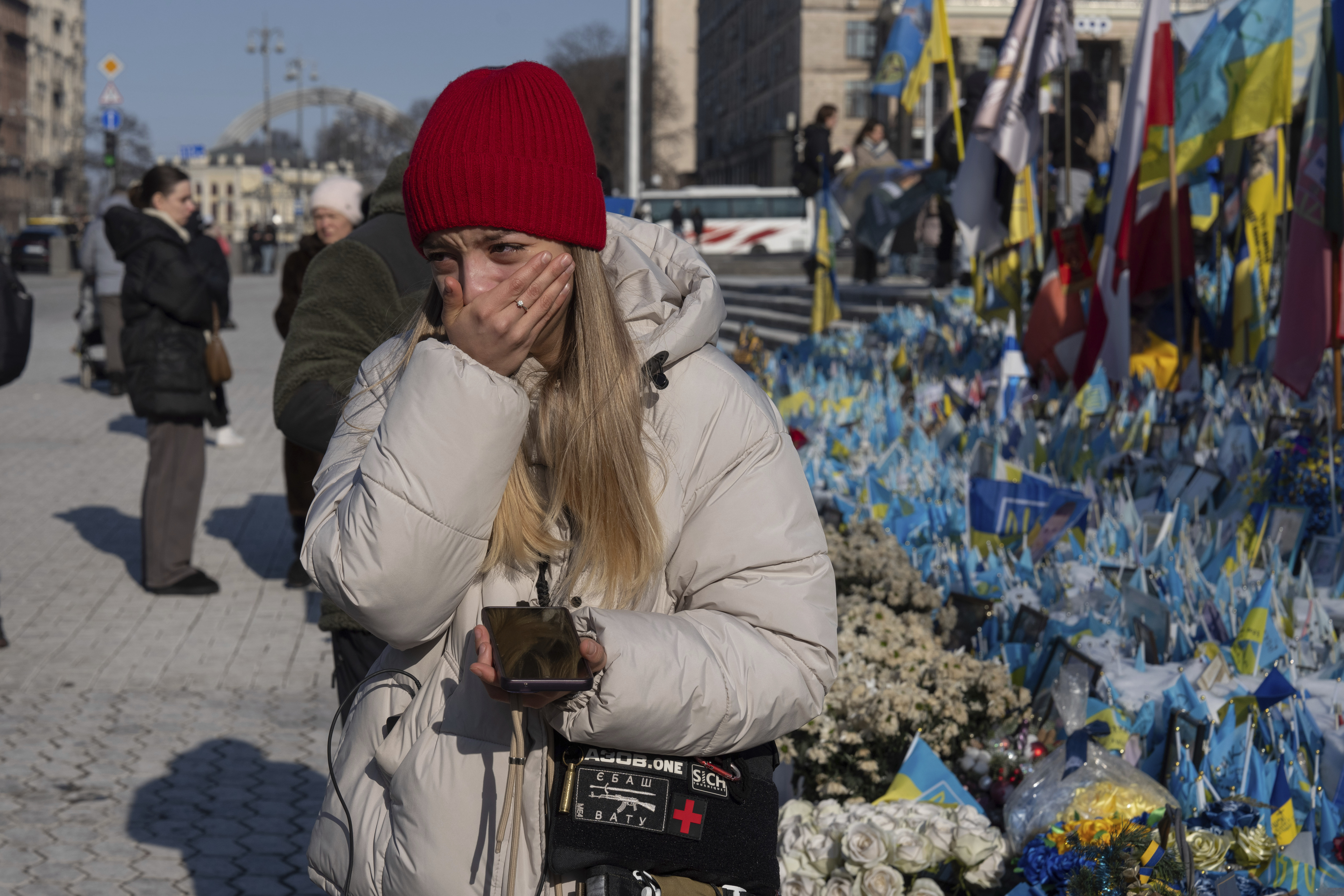 A woman cries at the memorial to the fallen Ukrainian soldiers on Independence Square in Kyiv, Ukraine, Monday, Feb. 24, 2025. (AP Photo/Efrem Lukatsky)