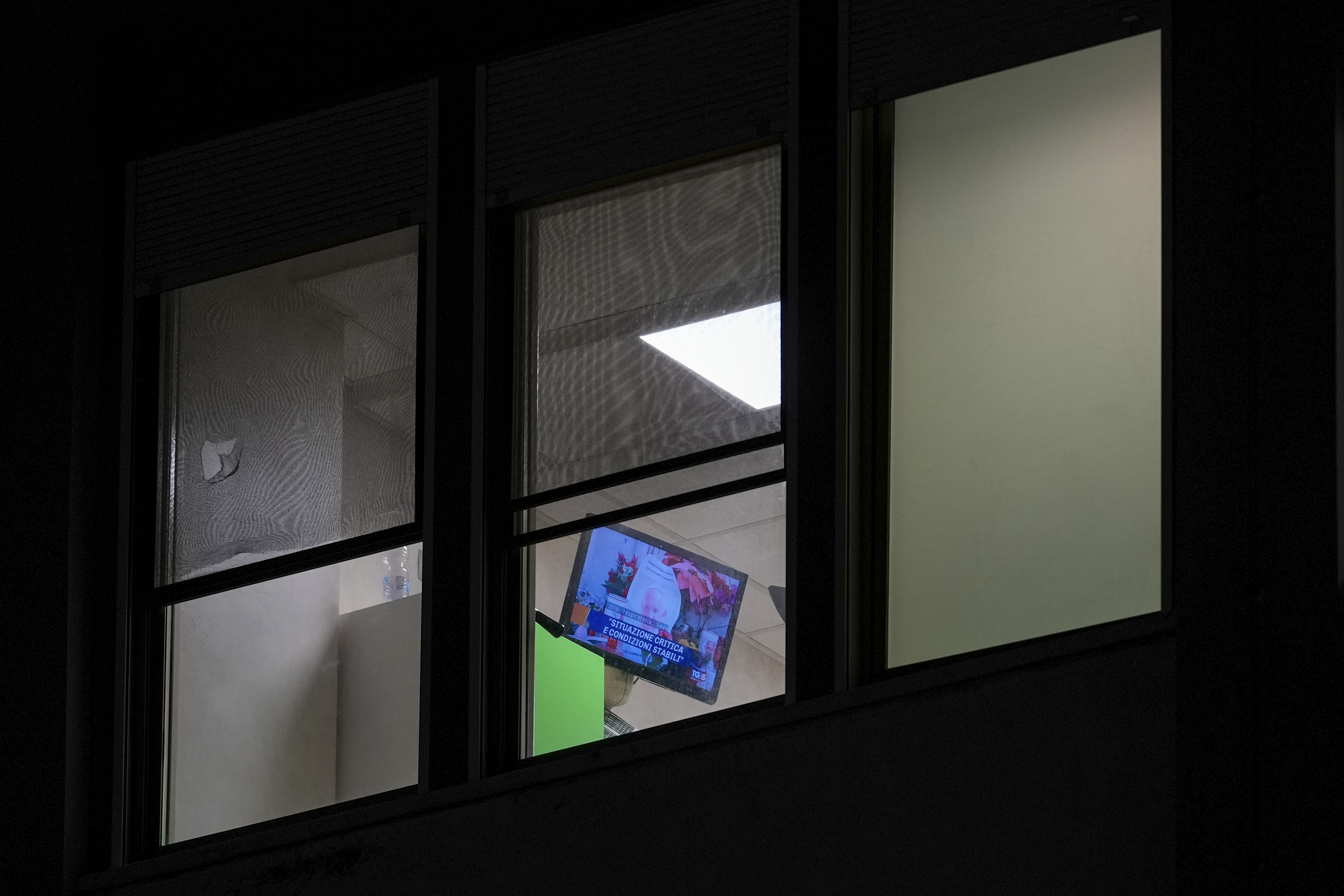 A television shows news about Pope Francis in a room of the Agostino Gemelli Polyclinic, in Rome, Sunday, Feb. 23, 2025, where the pontiff is hospitalized in stable but critical condition since Friday, Feb. 14. (AP Photo/Andrew Medichini)